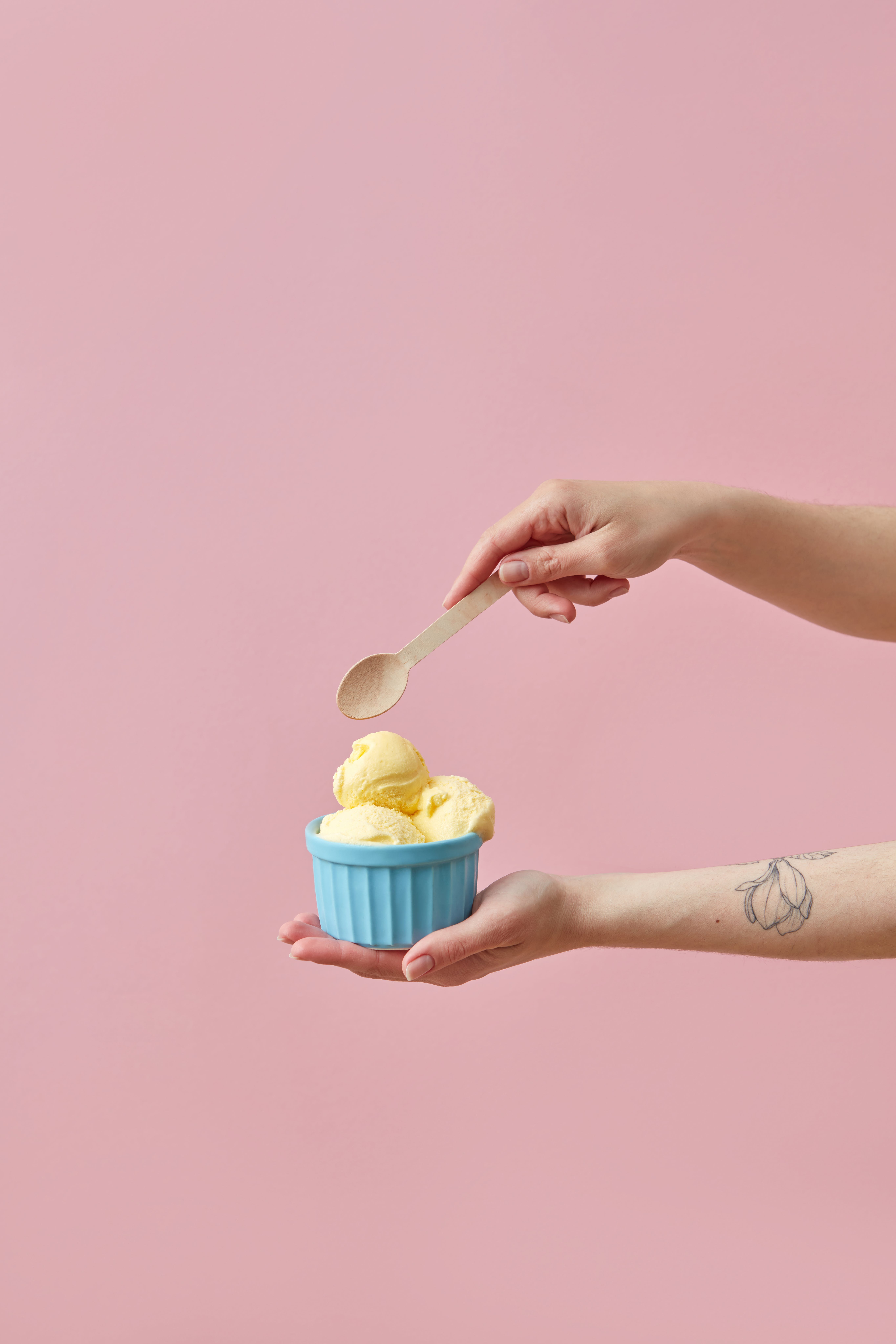 Woman Holding a Vanilla Ice Cream and a Wooden Spoon · Free
