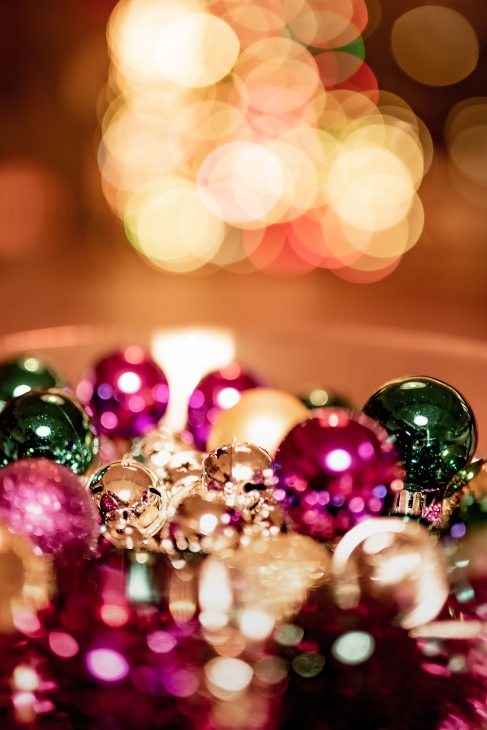 Green and pink baubles on brown wooden table photo