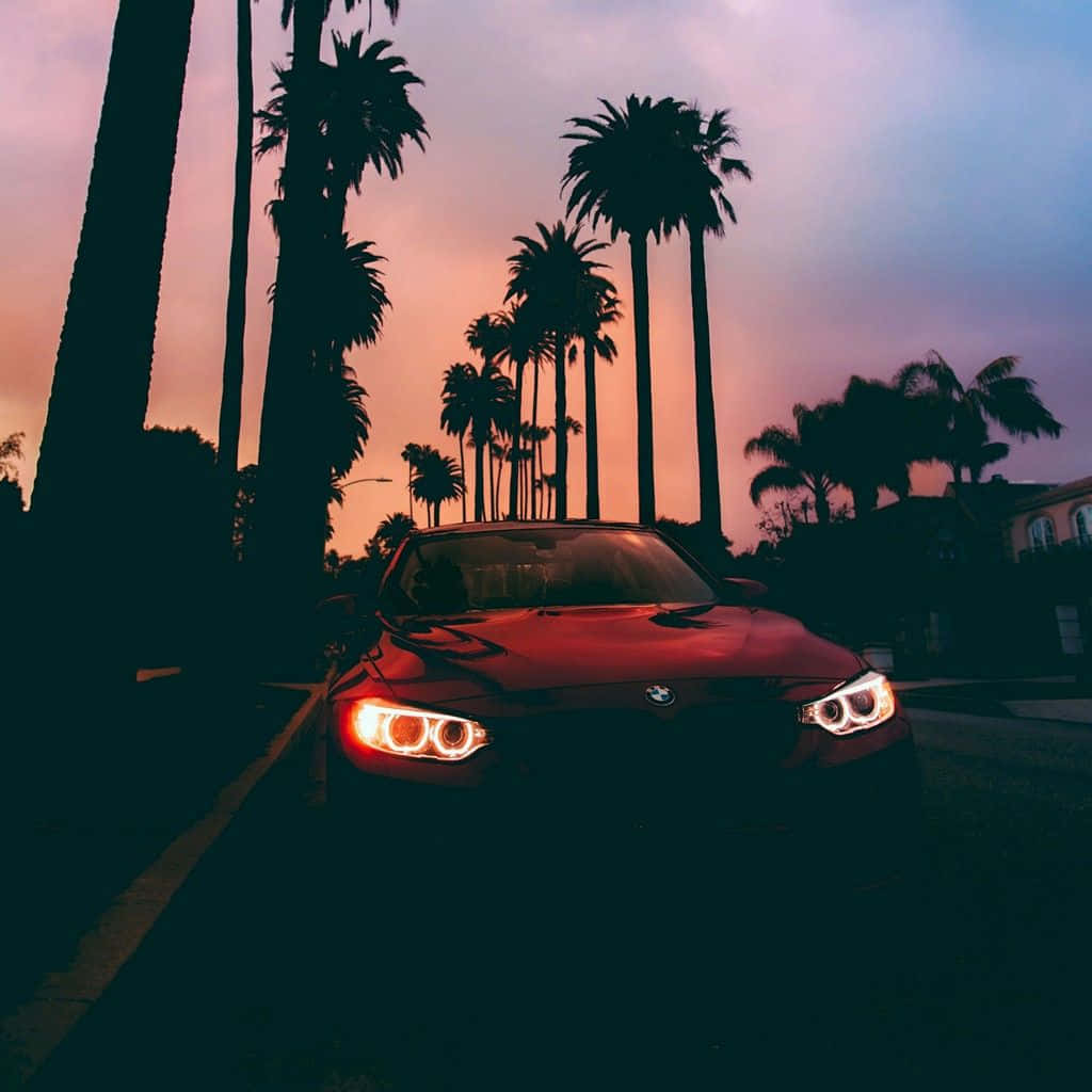Download Scenic Sunset Drive under an Orange Sky Wallpaper