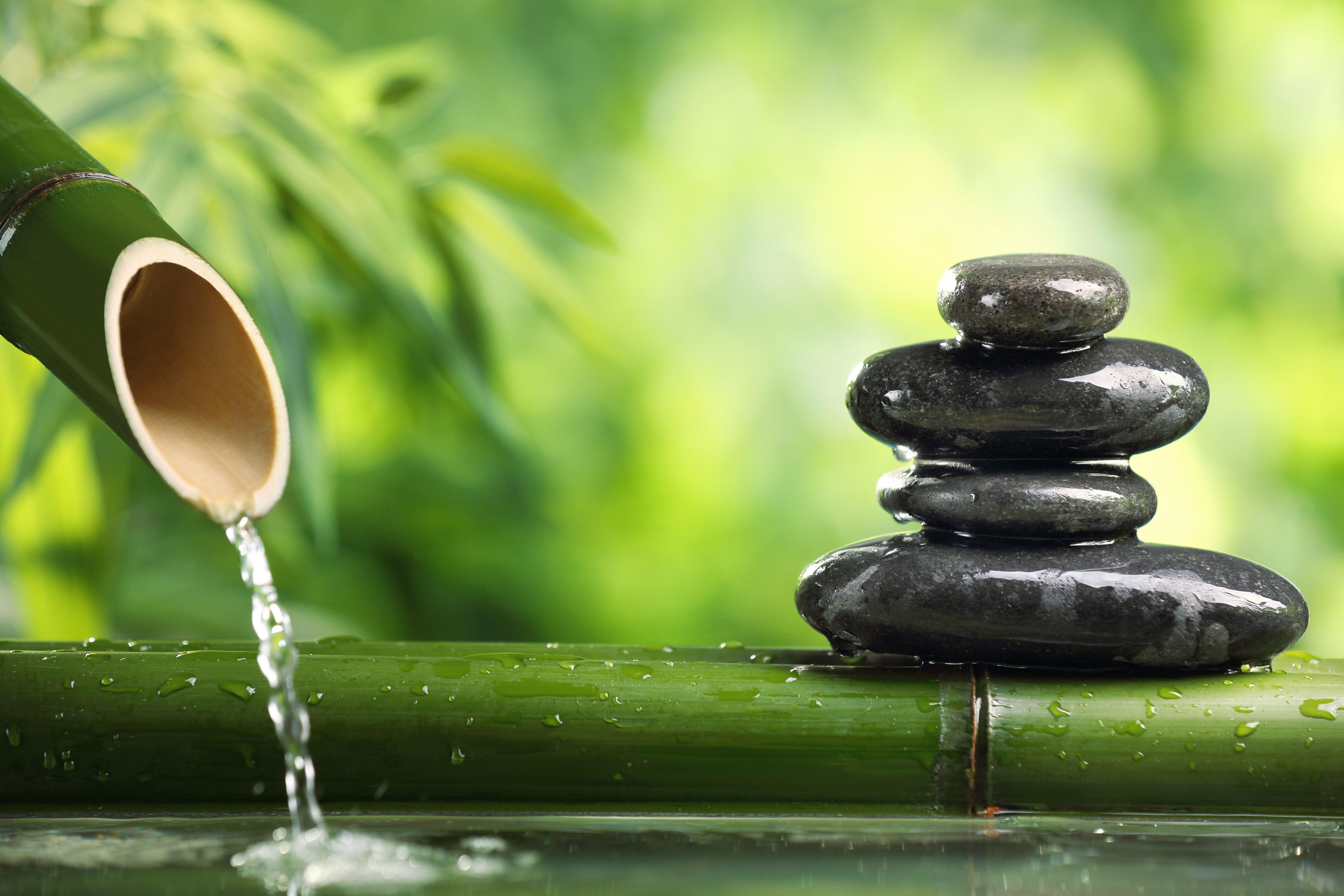 Zen Balance: Black Cairn Stones in a Tranquil Setting