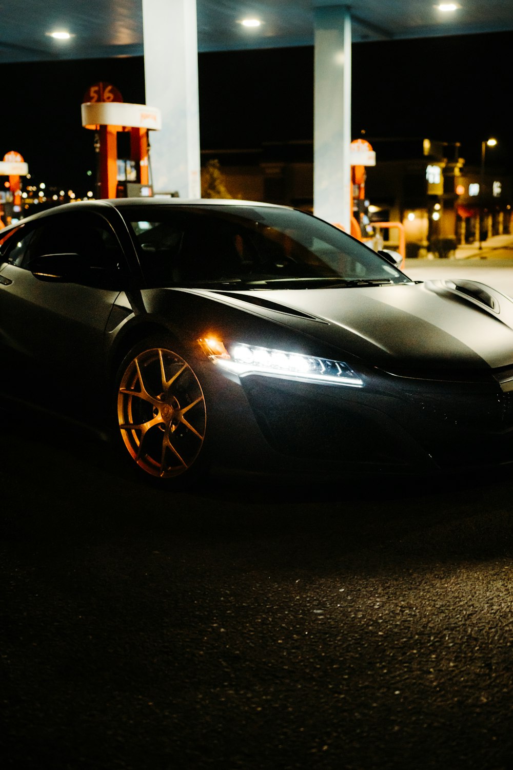 Black lamborghini aventador parked on parking lot during night time photo