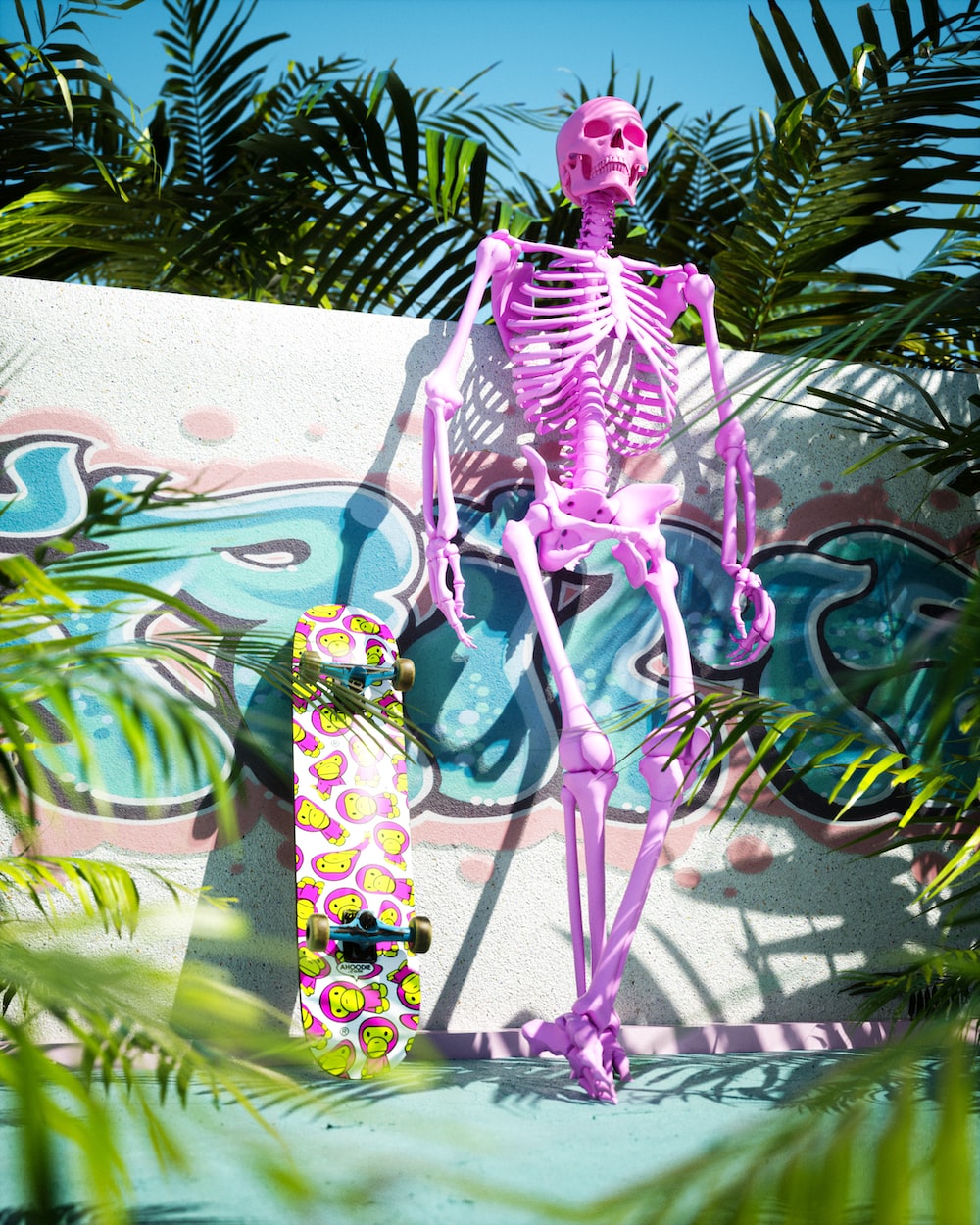 A pink skeleton sitting on top of a skateboard photo