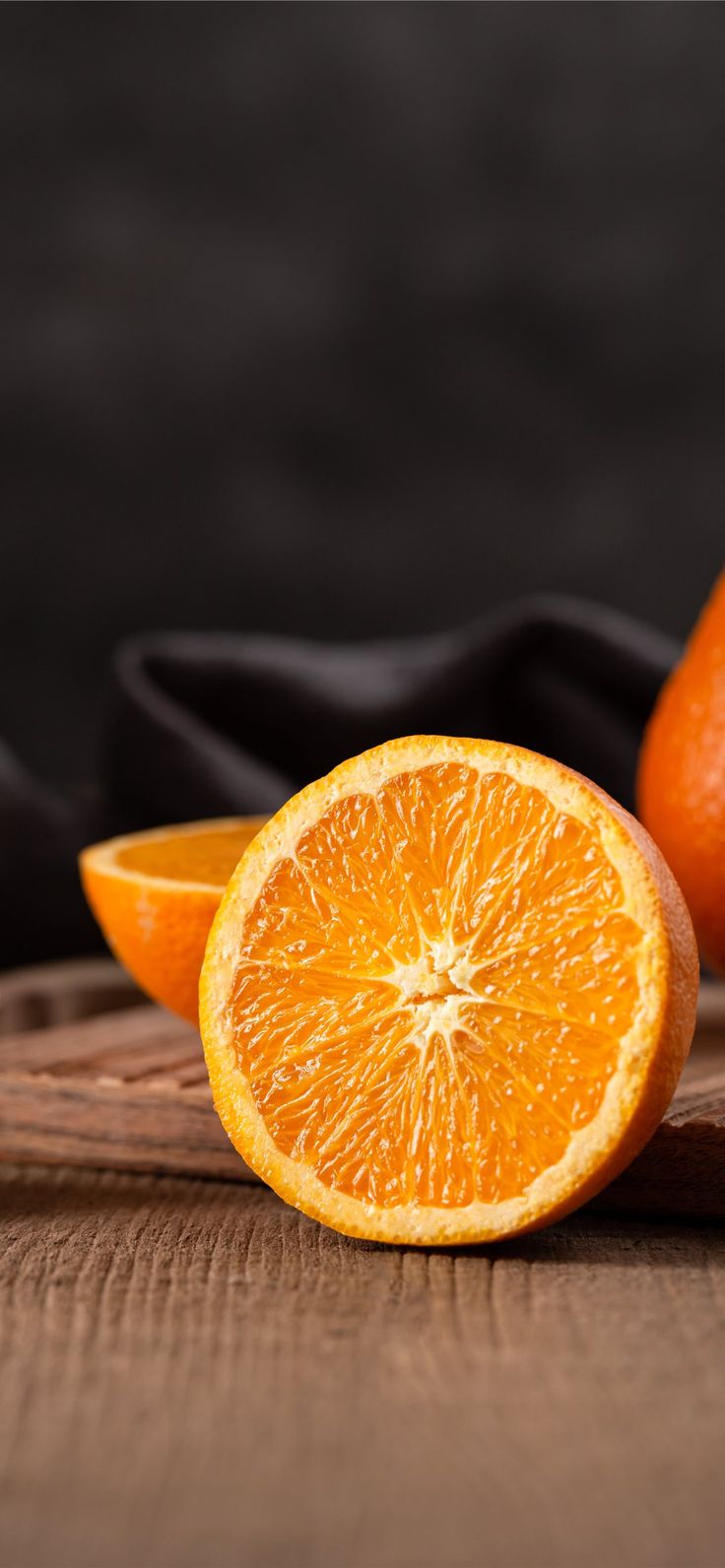 sliced orange fruit on brown wooden