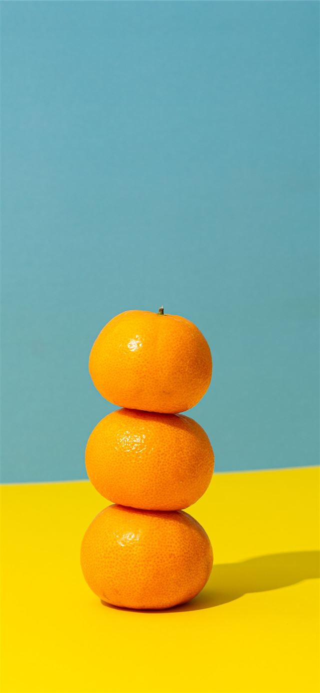 orange fruit on yellow surface iPhone 8