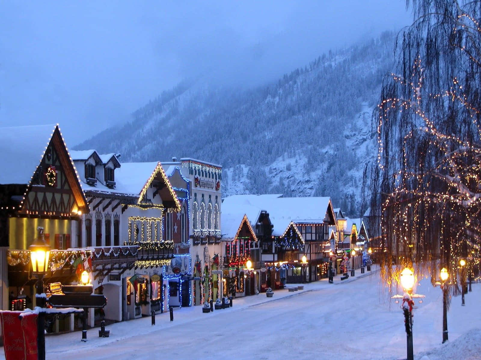 Download Pictureque Snowy Village Scene Wallpaper