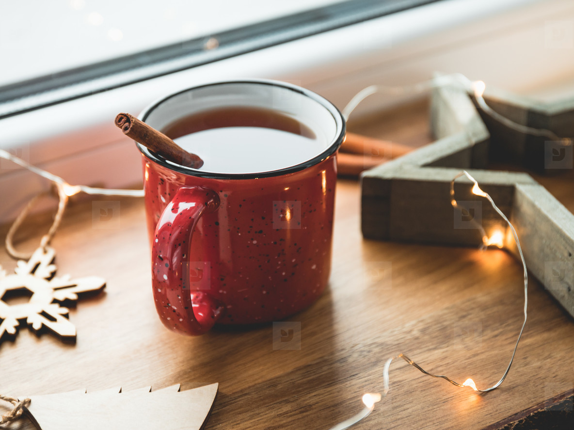 Black tea with cinnamon in a red mug