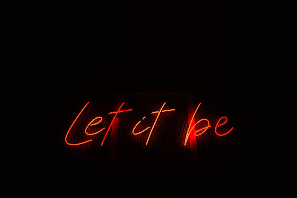 Red and Black Neon Light Sign on Black Background · Free