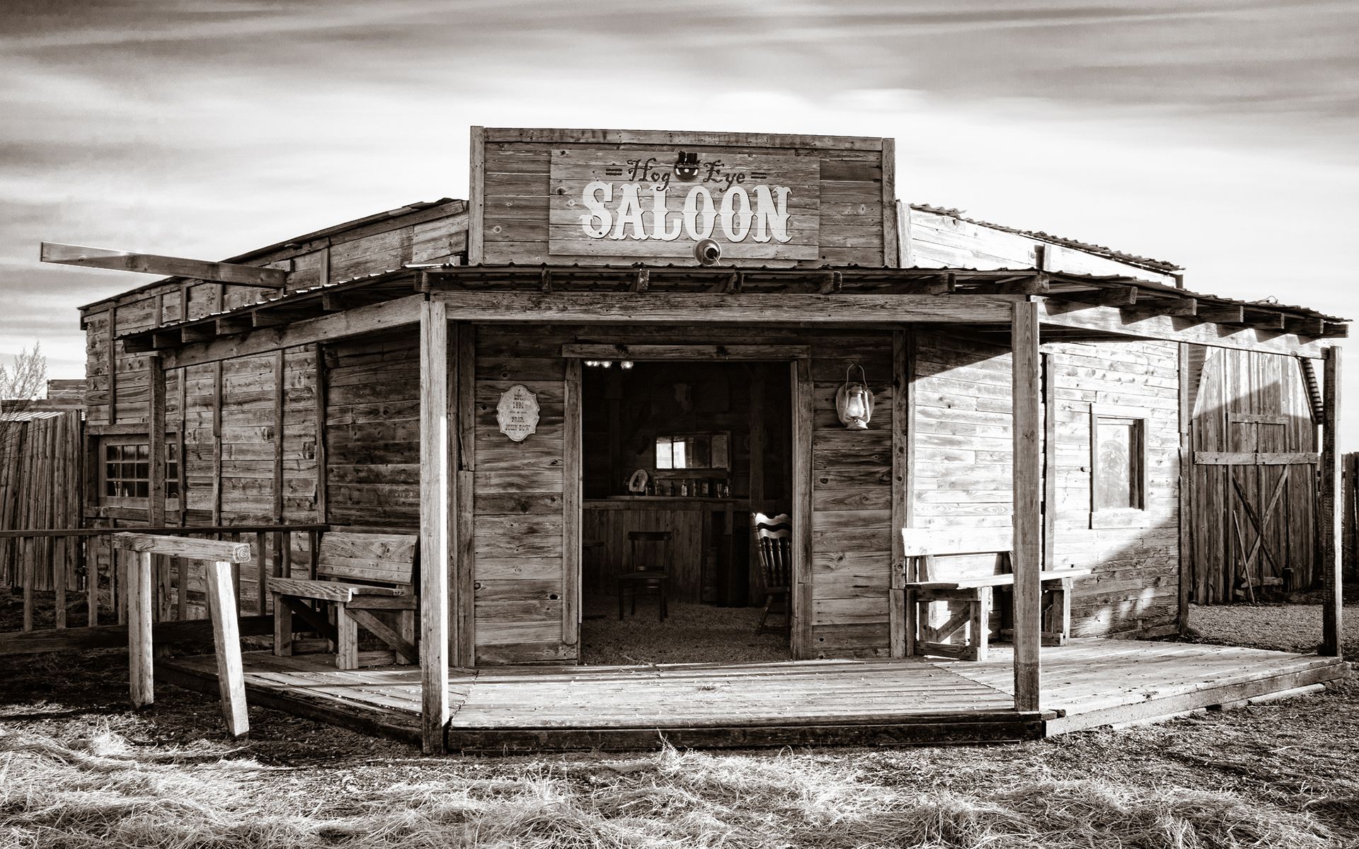 A typical Bar of the wild west, known as a saloon. They traditionally had large porches on a dirt floor. Made from woo. Old west saloon, Western saloon, Wild west
