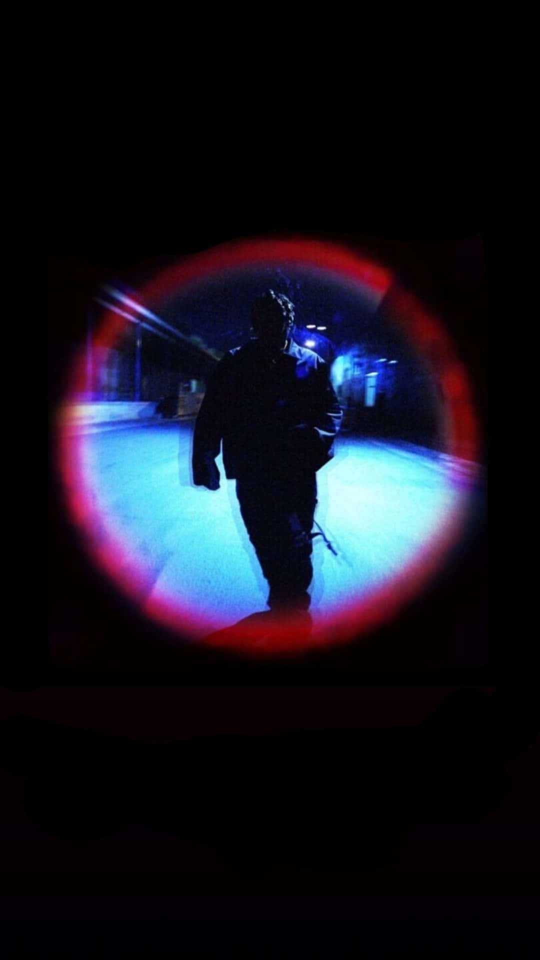 Download A Man Is Walking In The Dark With A Flashlight Wallpaper