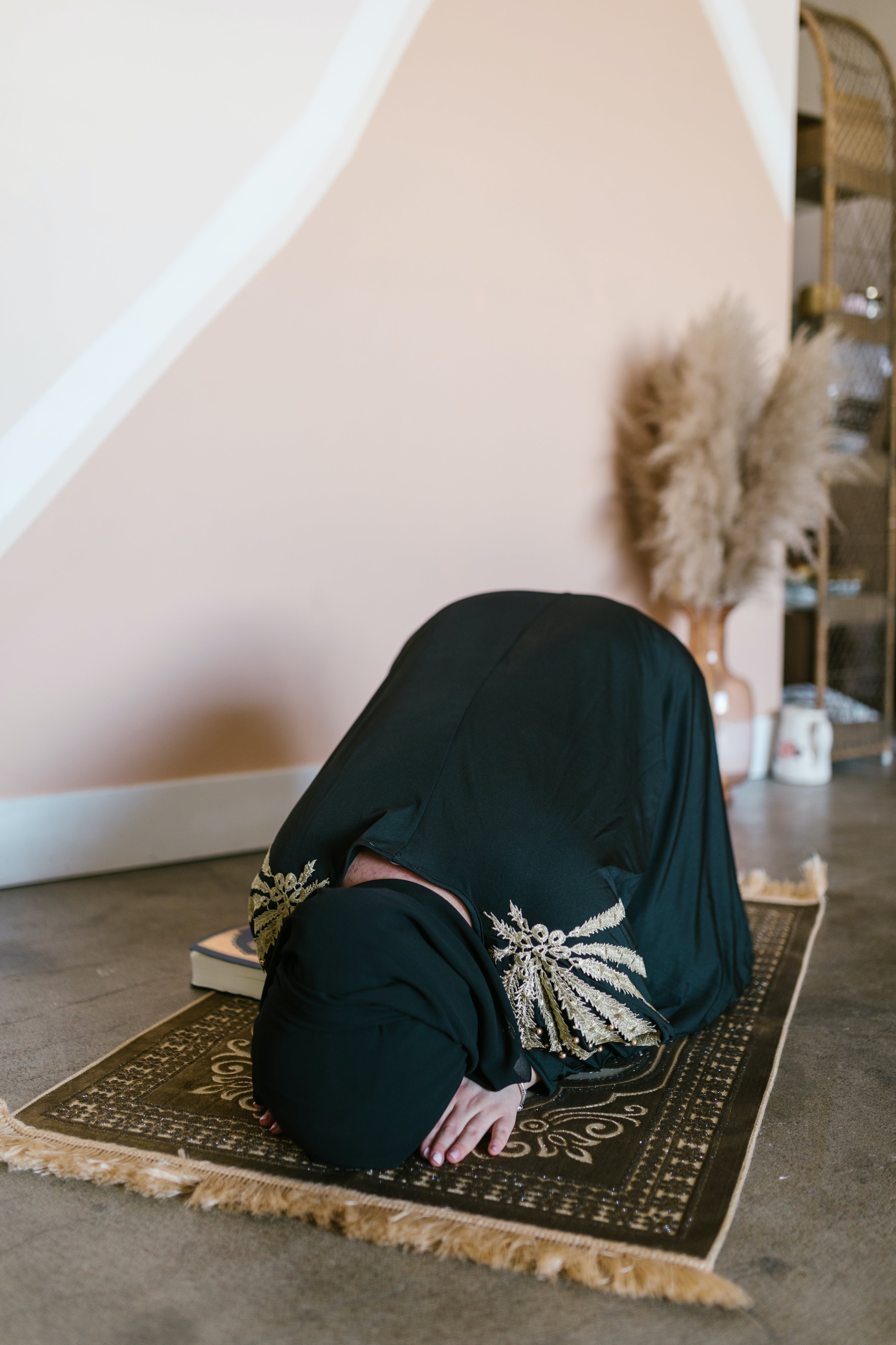 Woman Praying on a Prayer Rug
