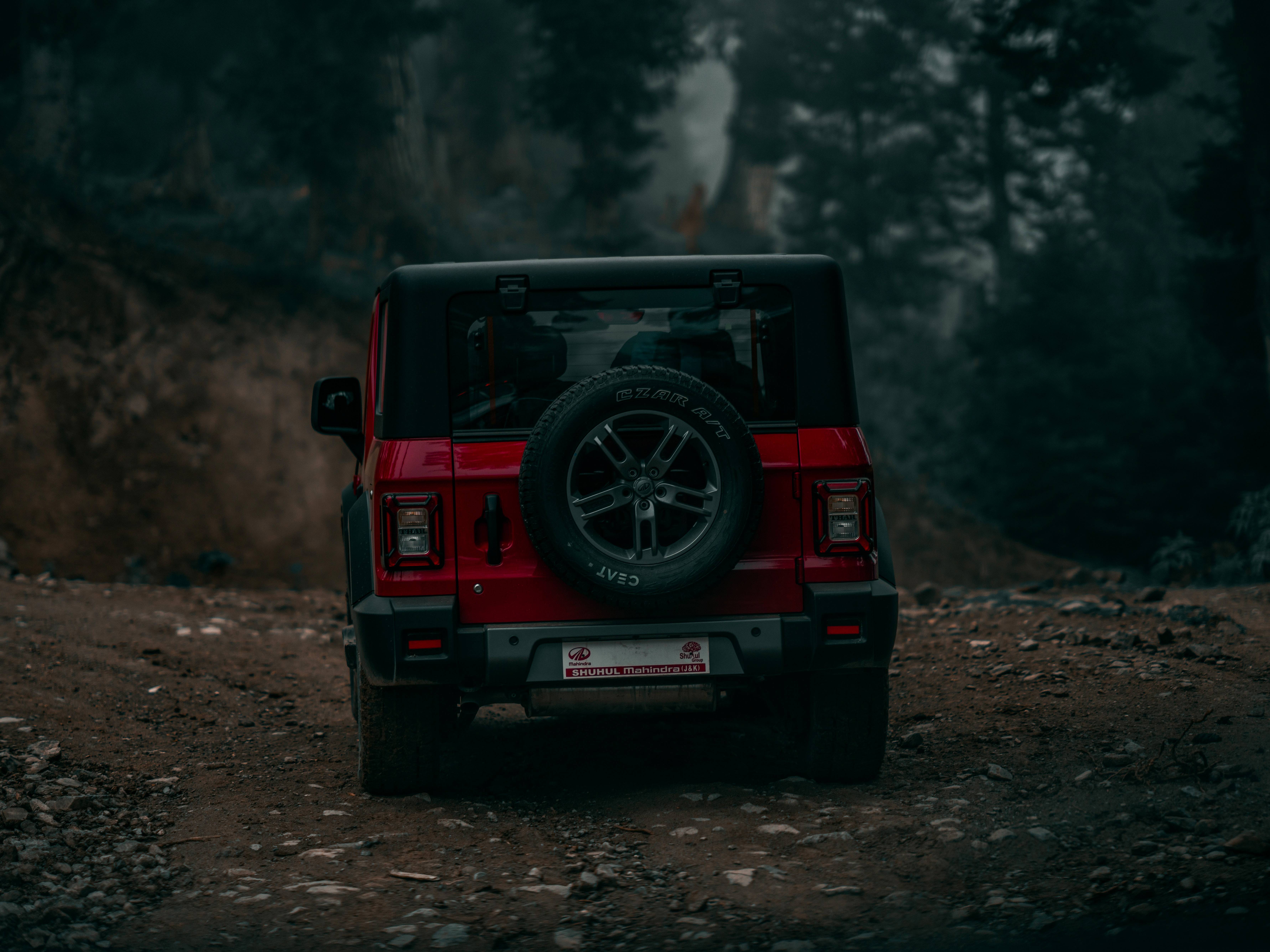 Red Mahindra Thar Parked On A Dirt Road