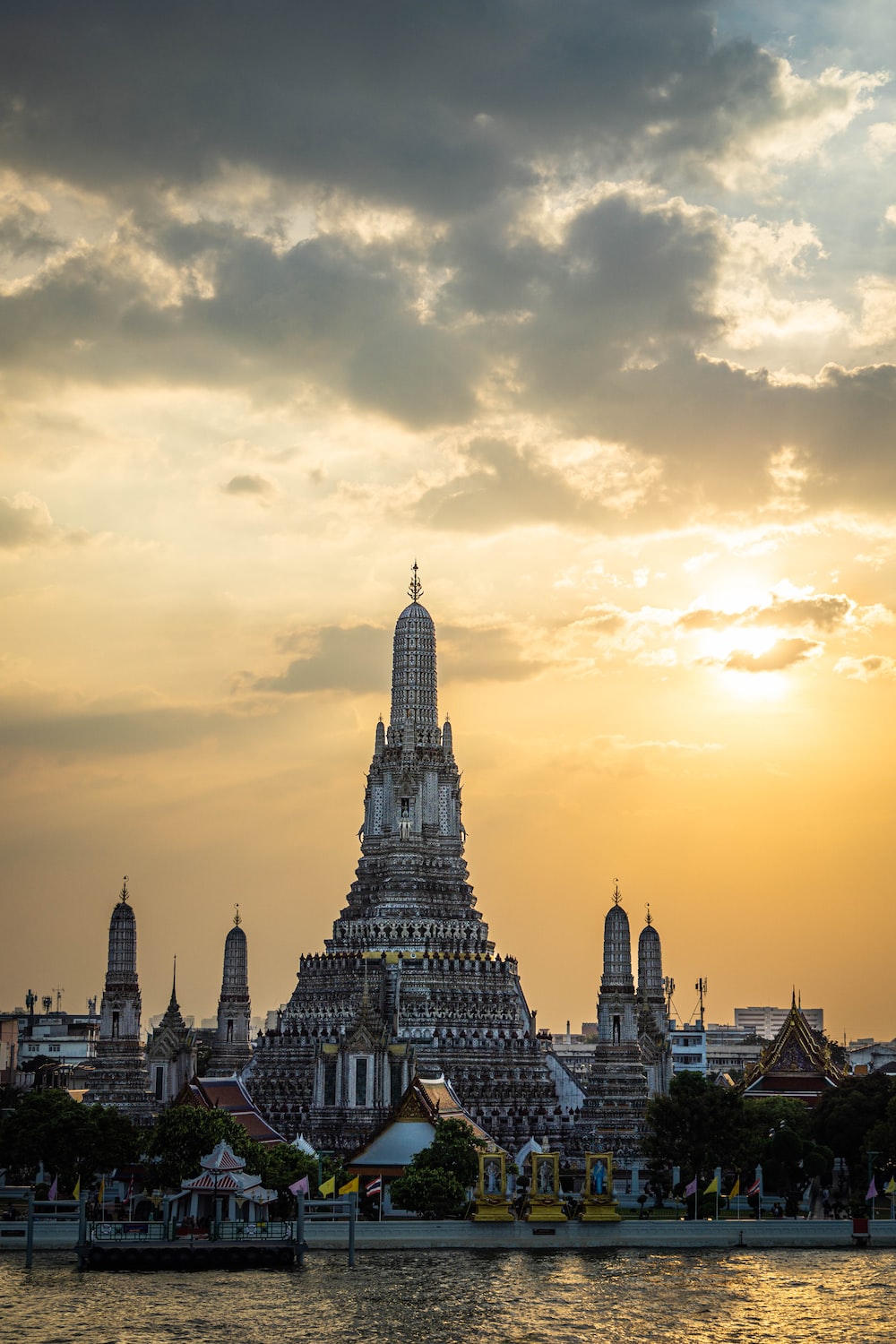 towers by a body of water with Wat Arun