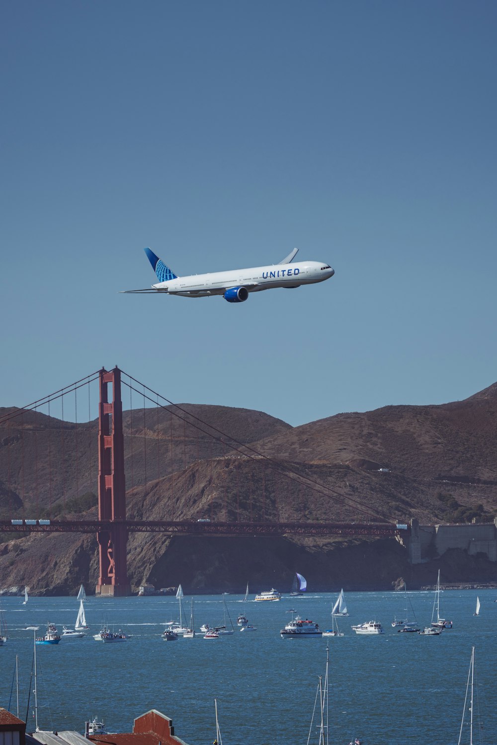 A large jetliner flying over a body