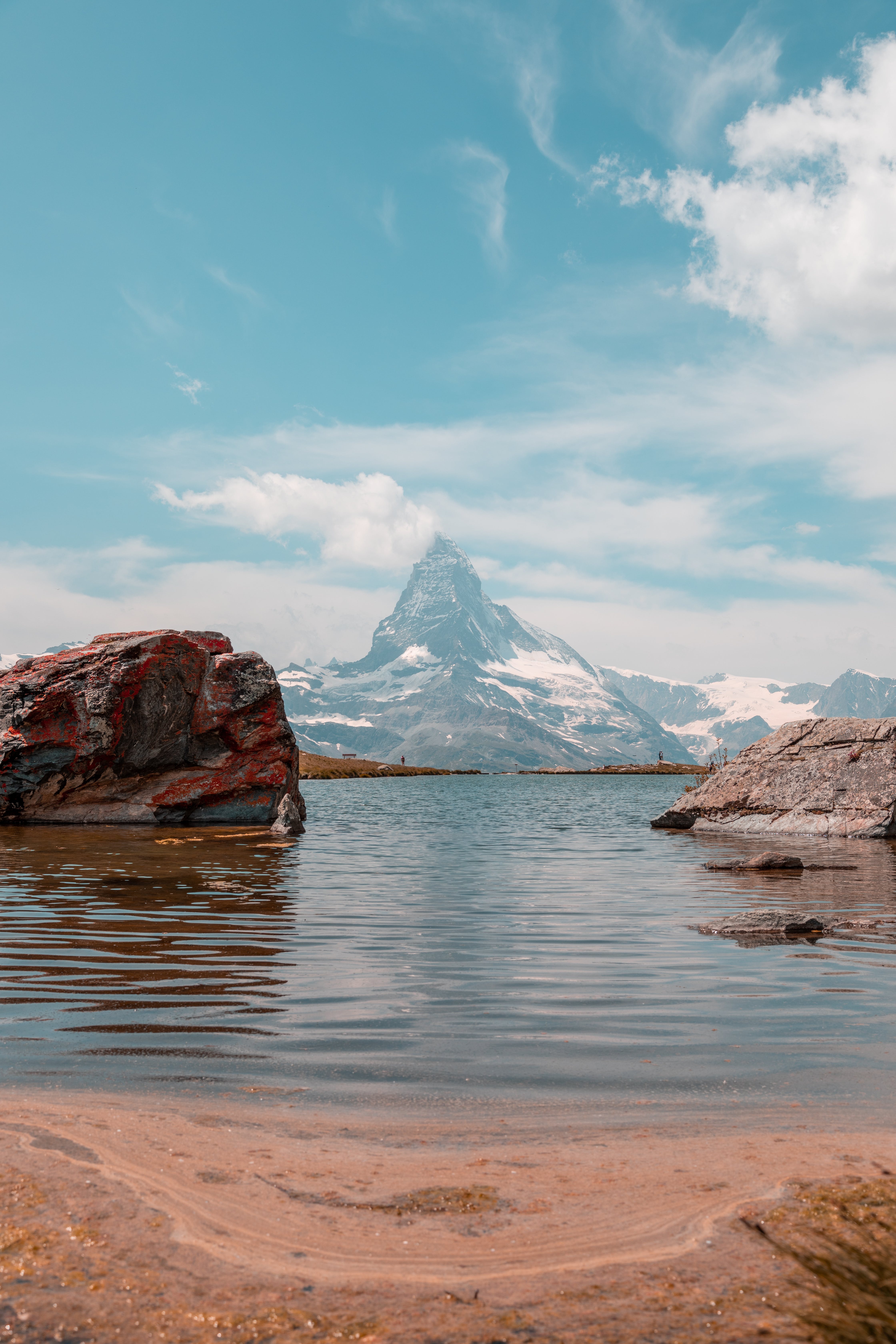 Lake Near Mountain Under Blue Sky