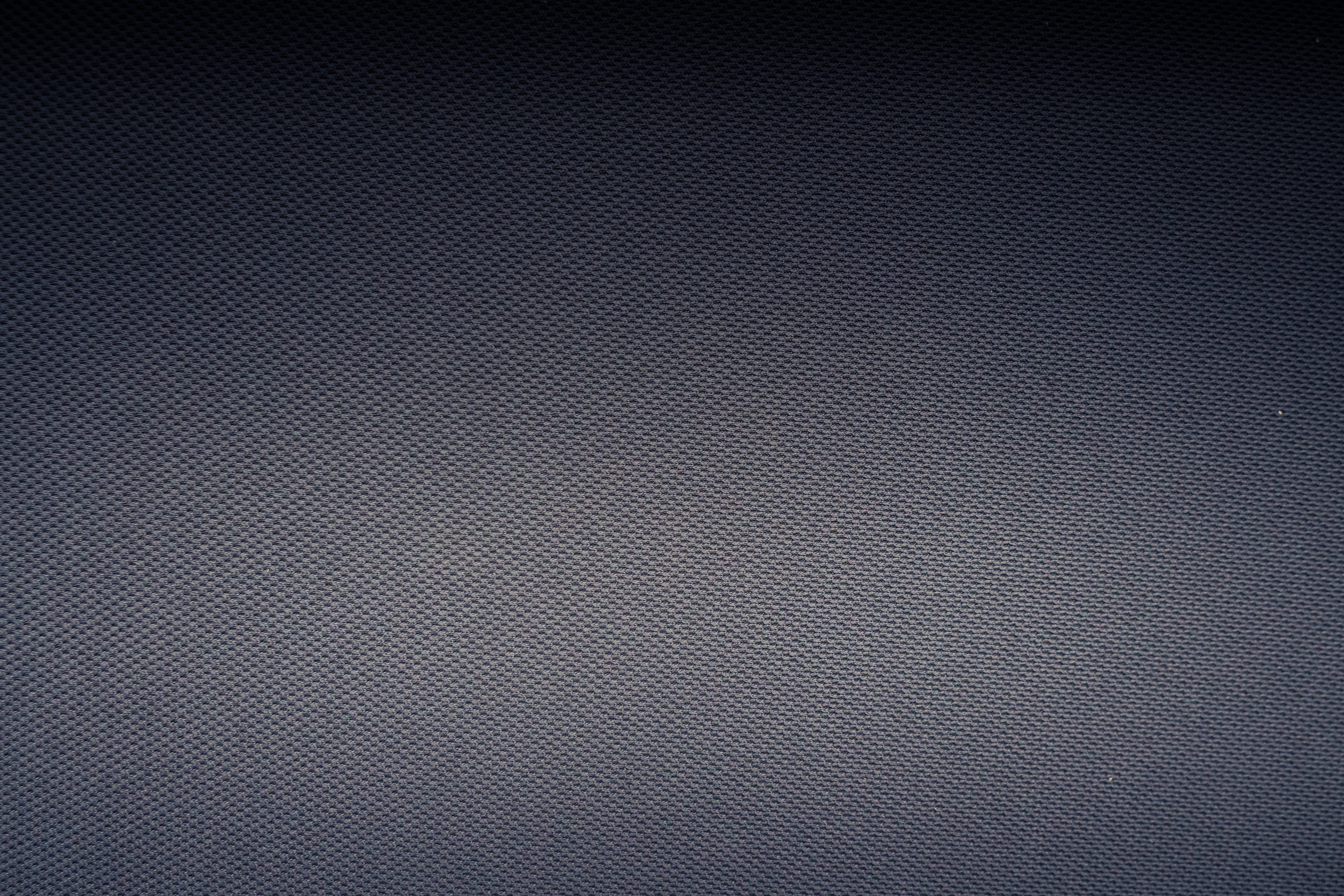Textured background of carbon fiber fabric with tiny holes · Free