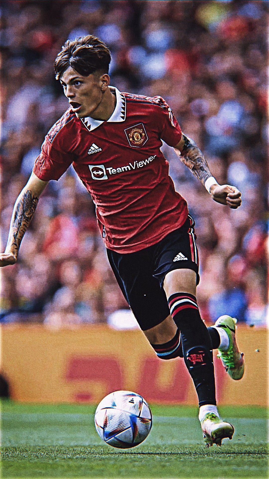 Man Kicking Soccer Ball on Field