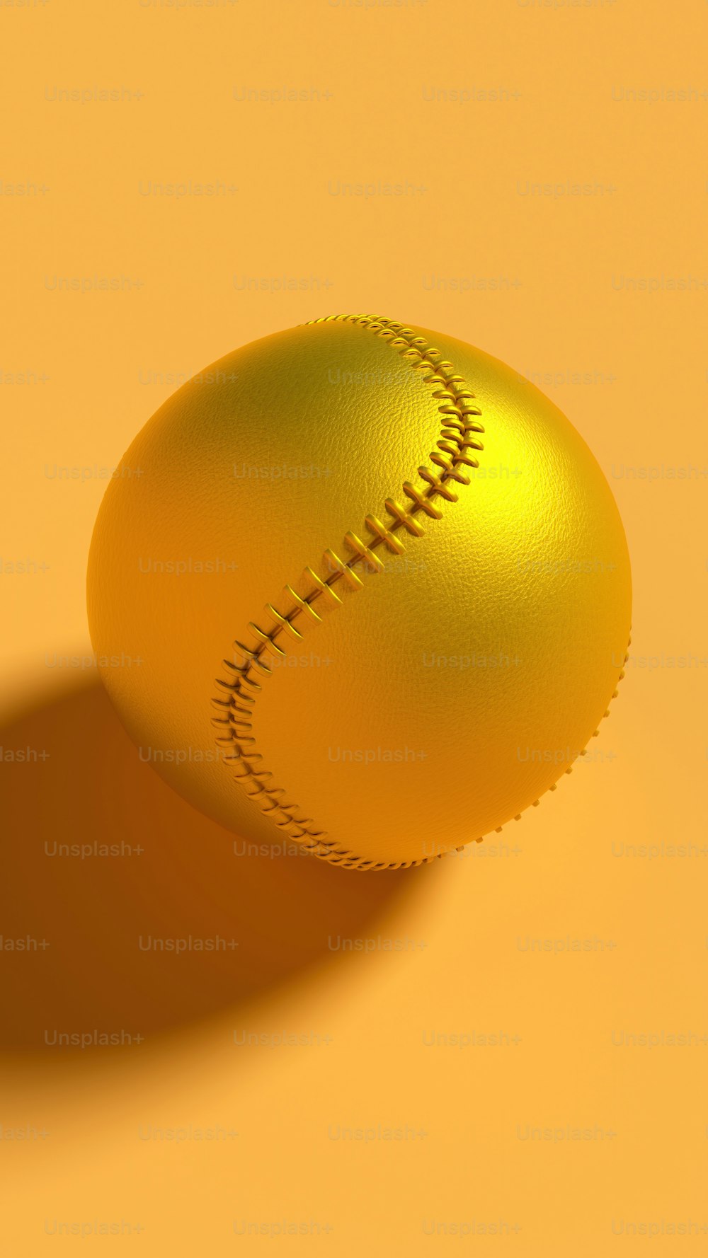 A golden baseball ball on a yellow