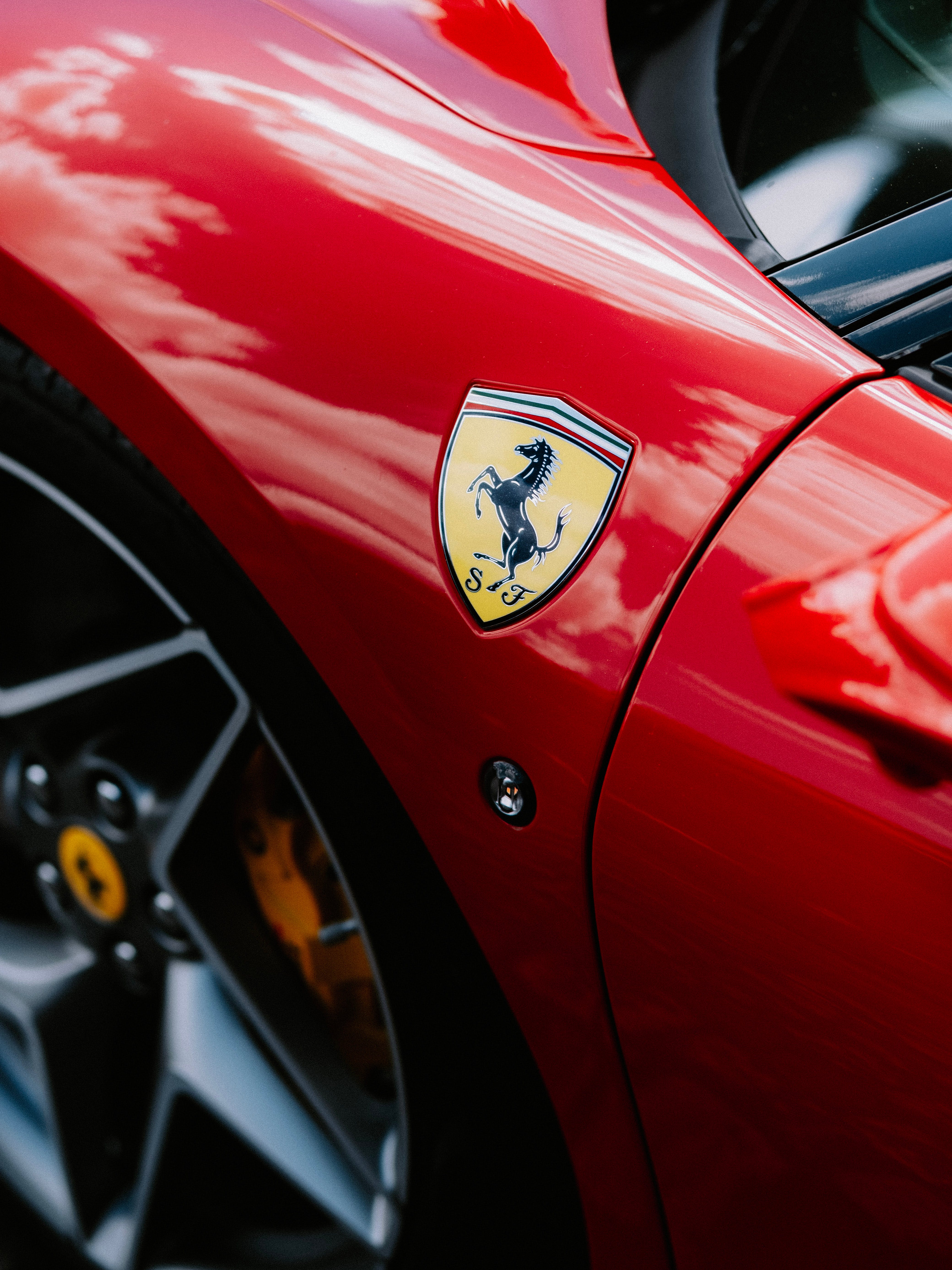 A Ferrari Logo on a Red Car in Close Up