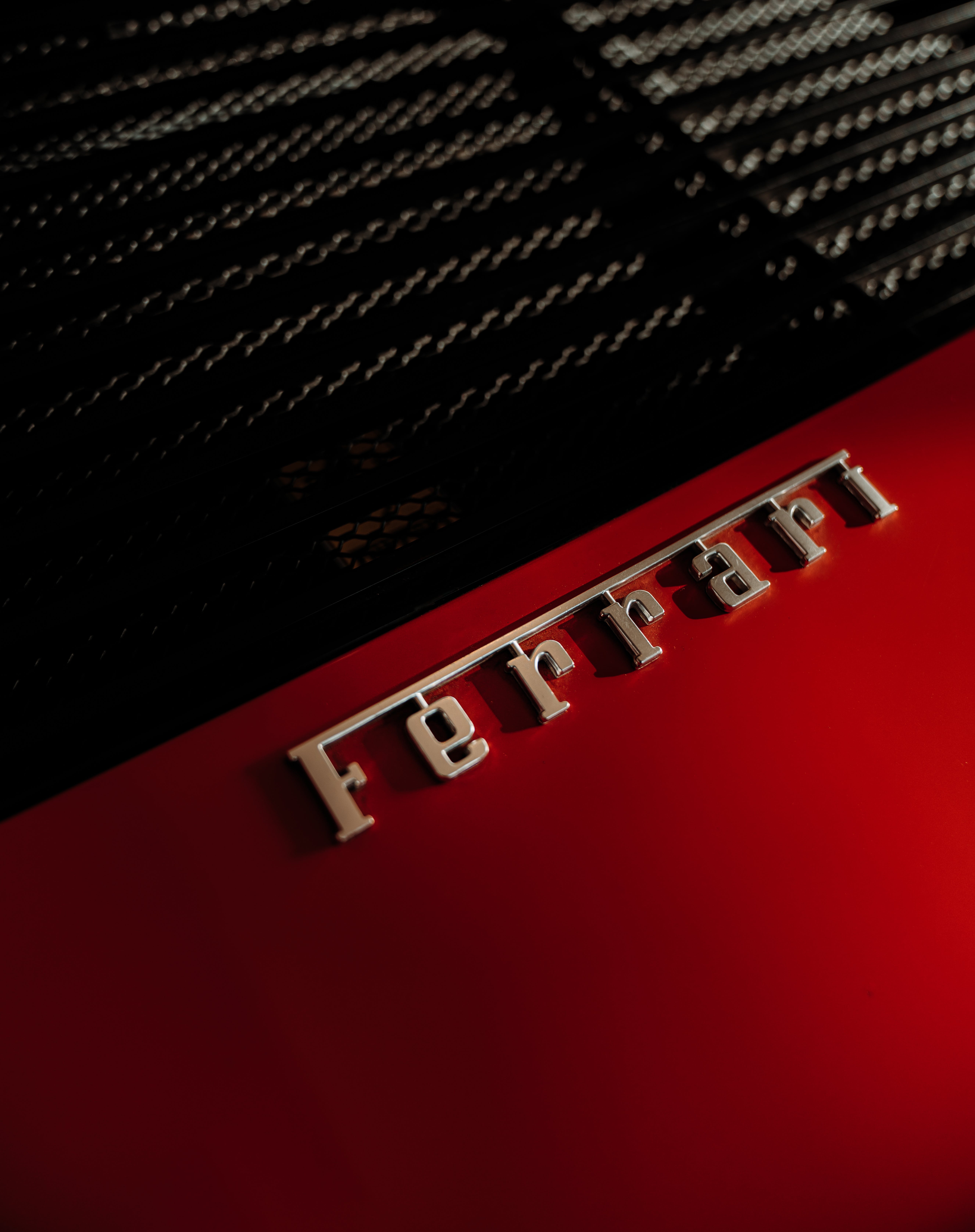 A Ferrari Logo on a Red Car in Close Up