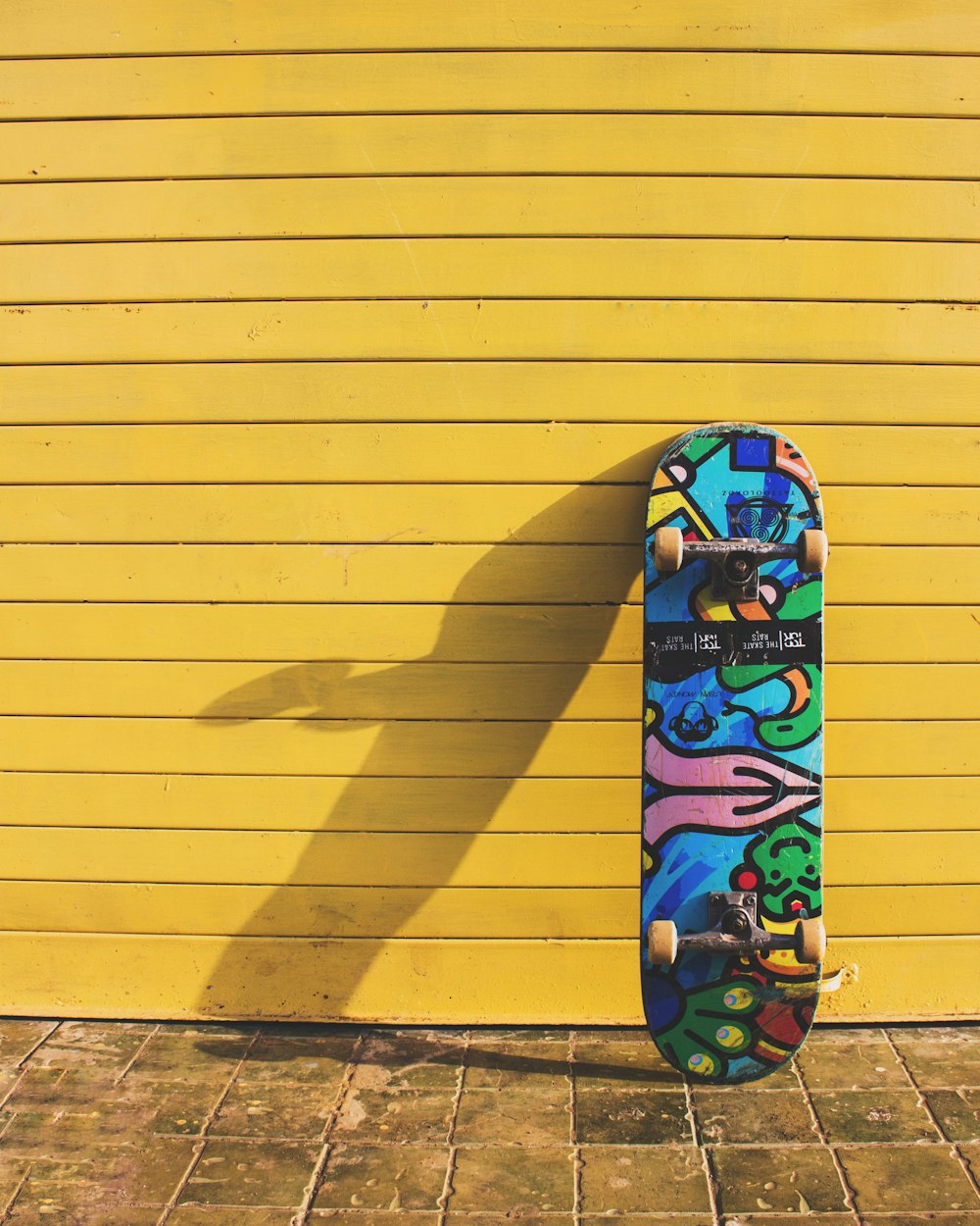 Photo of blue multicolored skateboard