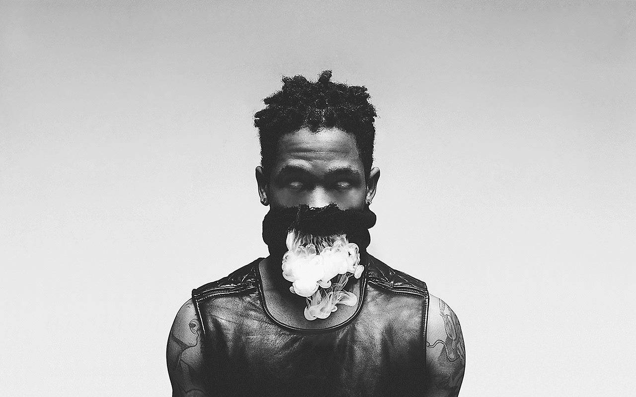 Travis Scott Rapping on Stage Wallpaper