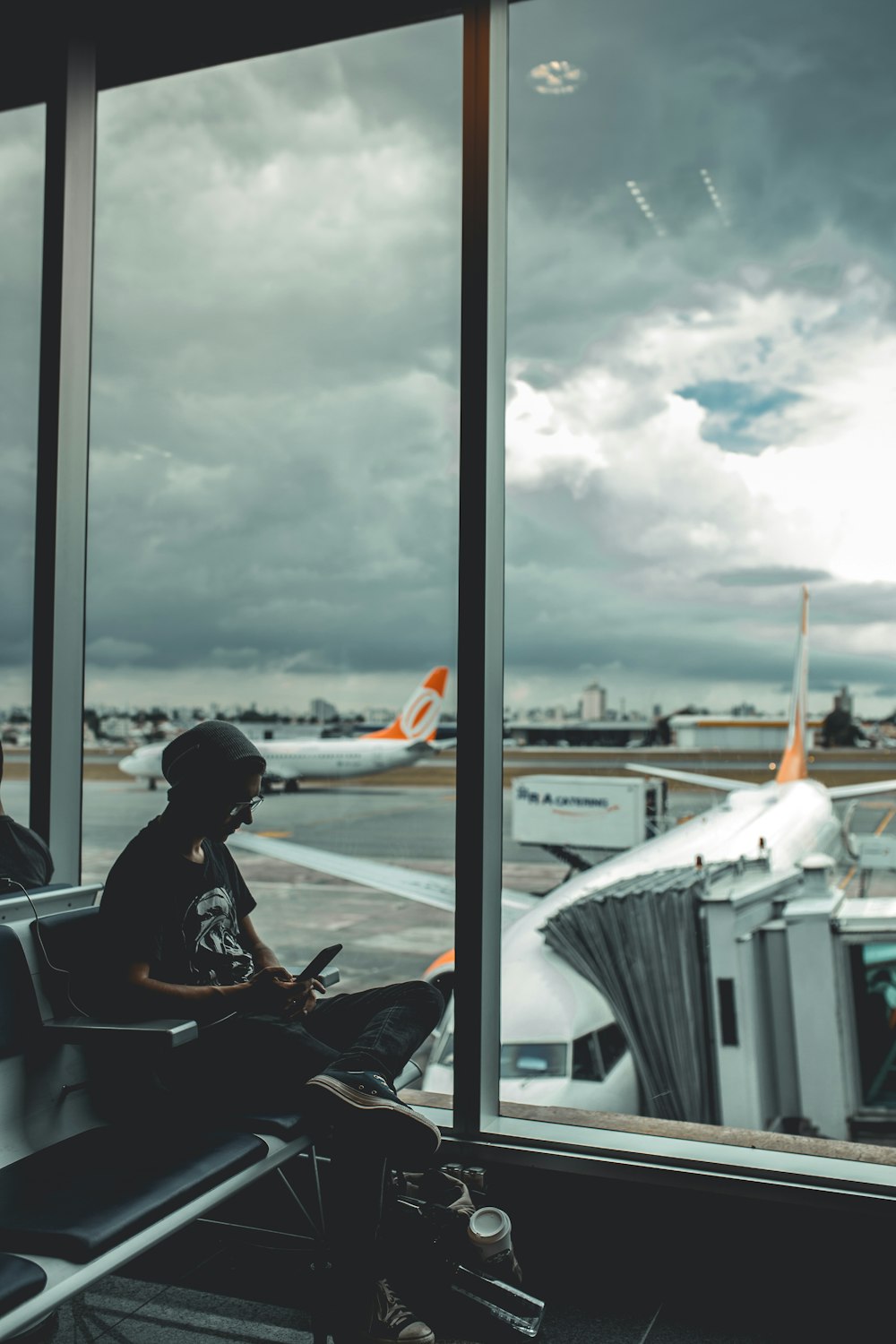 Man browsing his phone in airport photo
