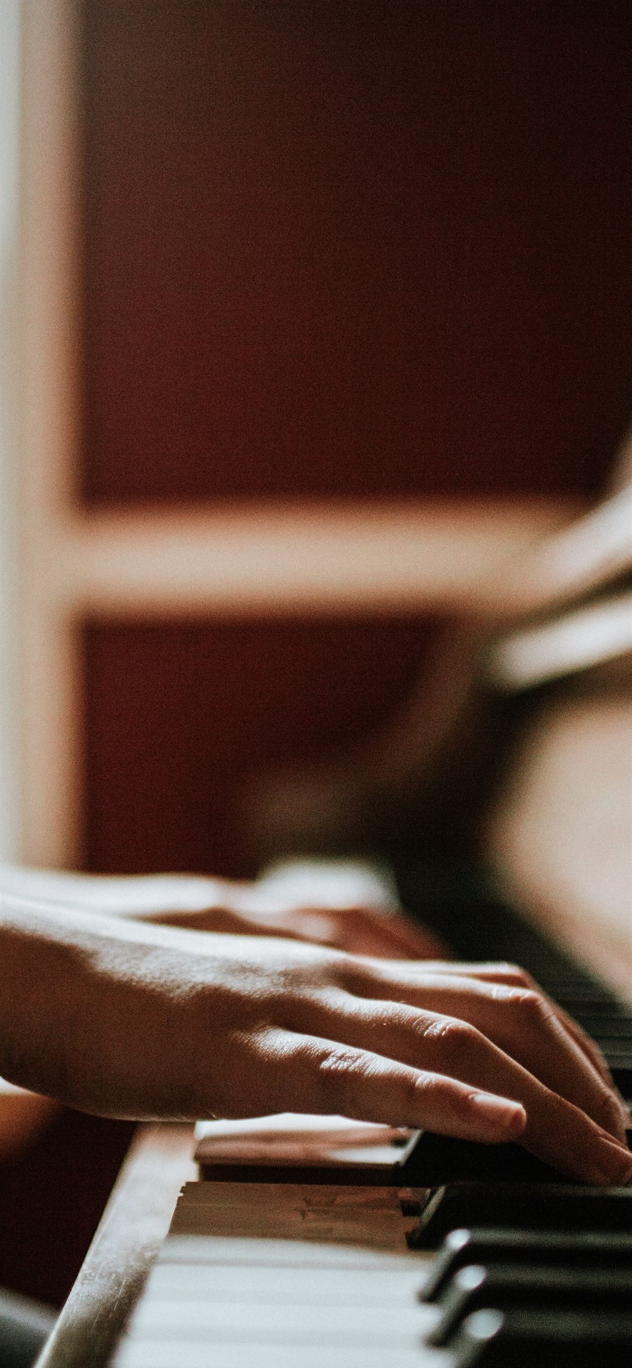 person playing piano iPhone Wallpaper