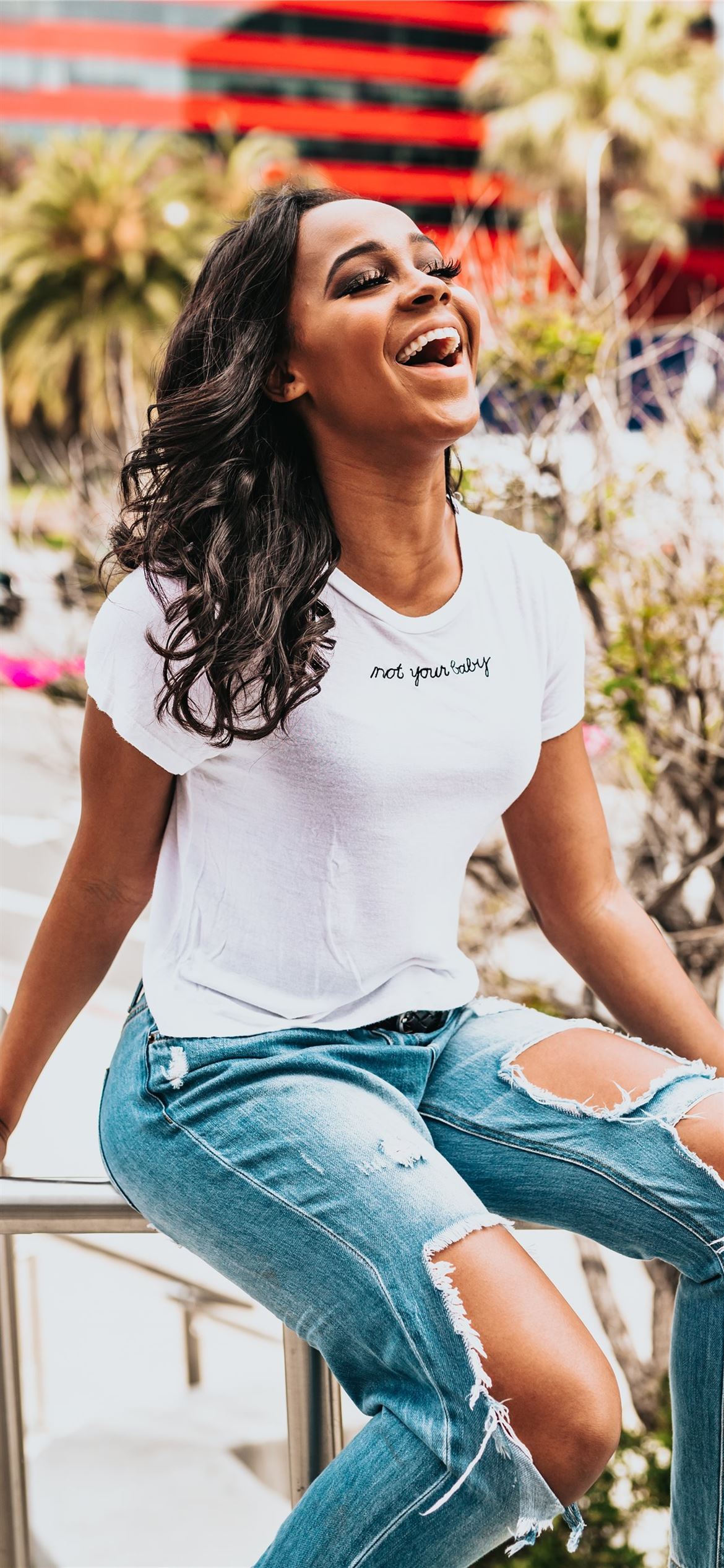 girl sitting on metal hand rail while