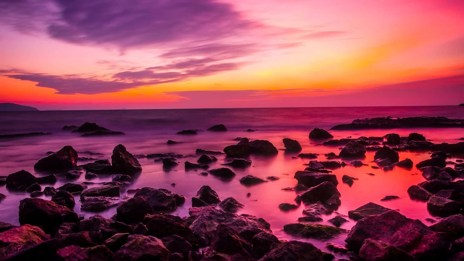 sunset with rocks and a colorful sky