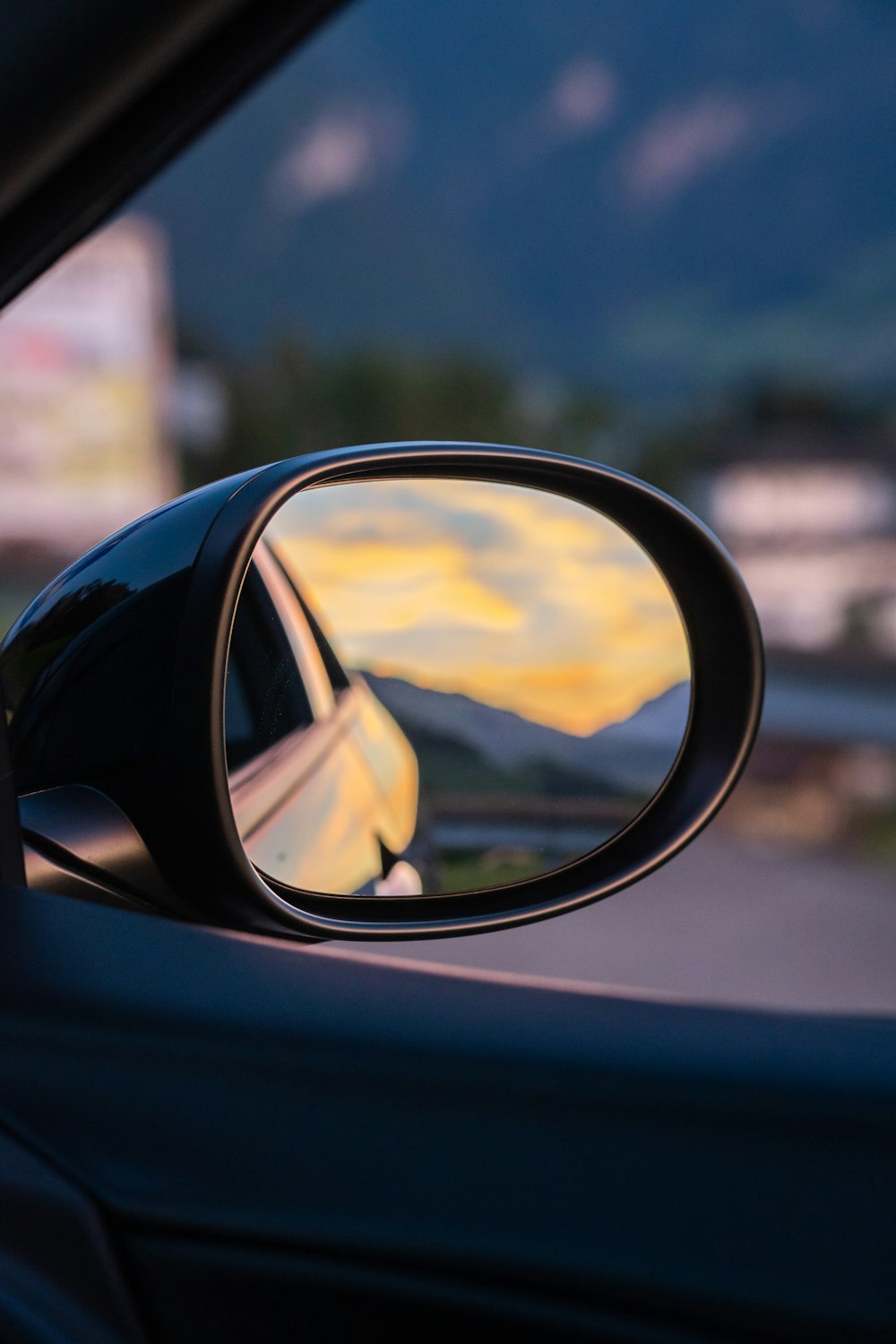mirror showing a yellow sunset photo