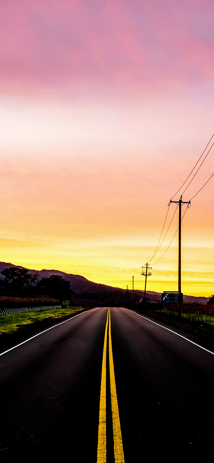 Black road near a mountain at sunset 4K