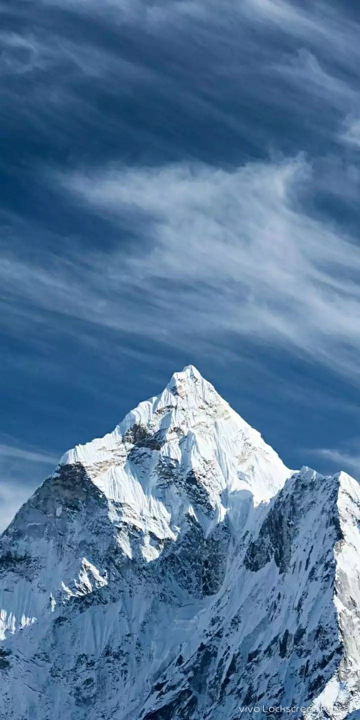Snow Covered Mountain in a Cloudy Blue Sky