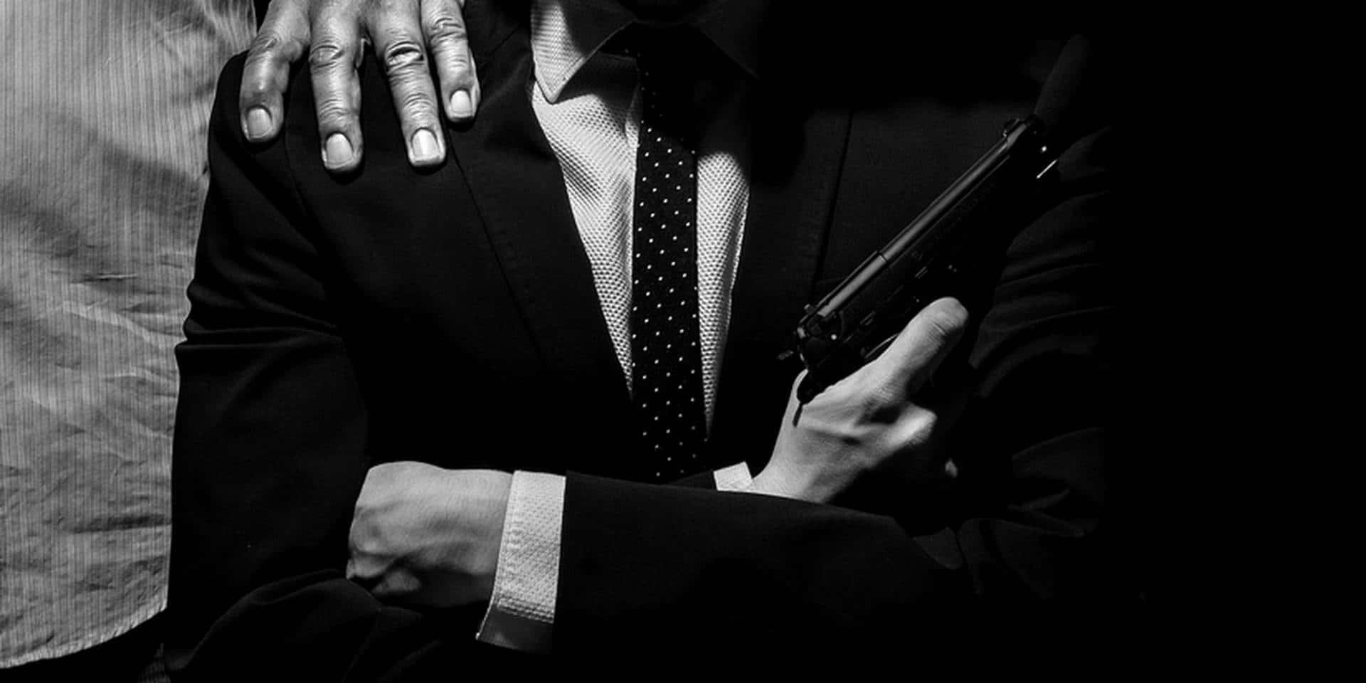 Suit And Tie Holding A Gun