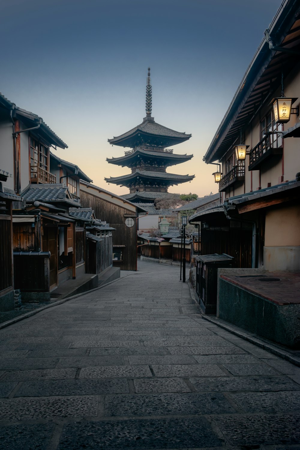 An empty street with a pagoda in