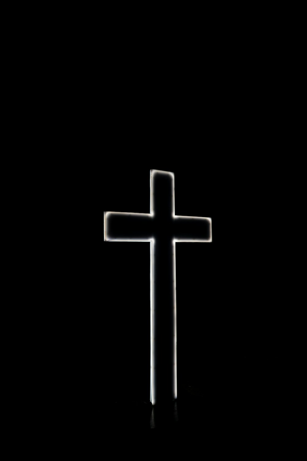 White cross with black background photo