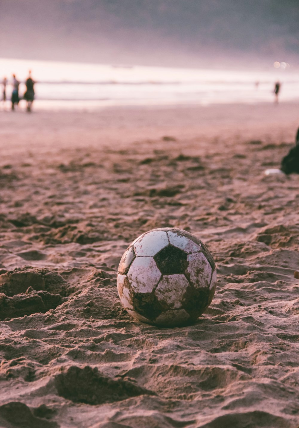 white soccer ball on brown sand