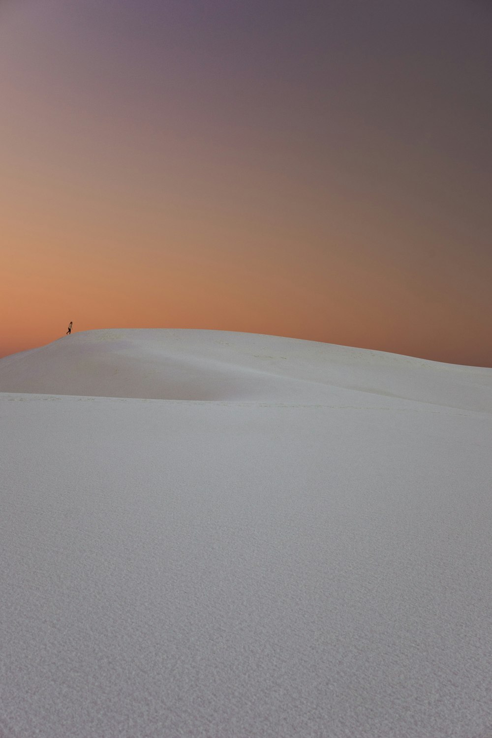 Person walking in the desert dunes