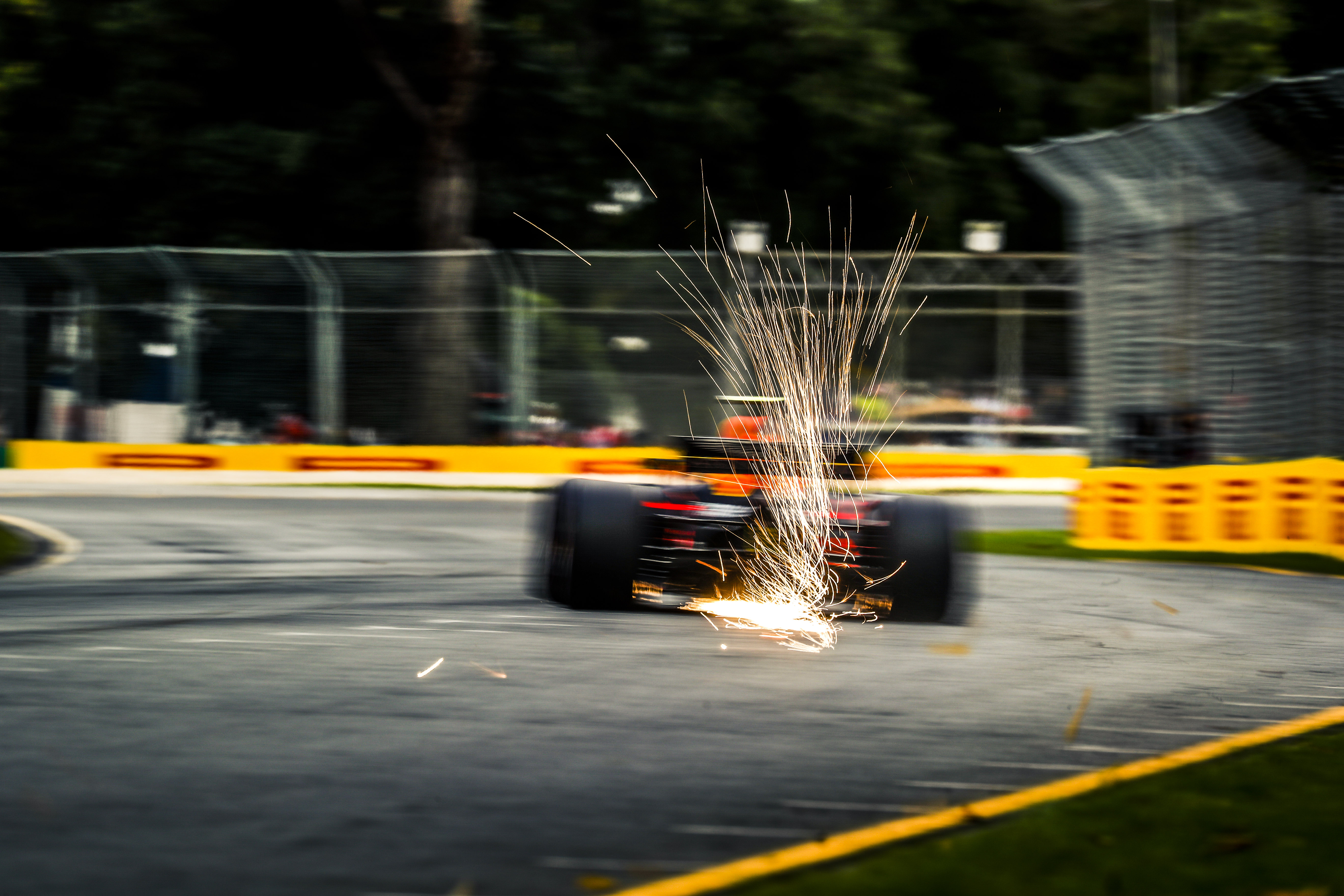 A Red Bull Racing RB14 throwing sparks