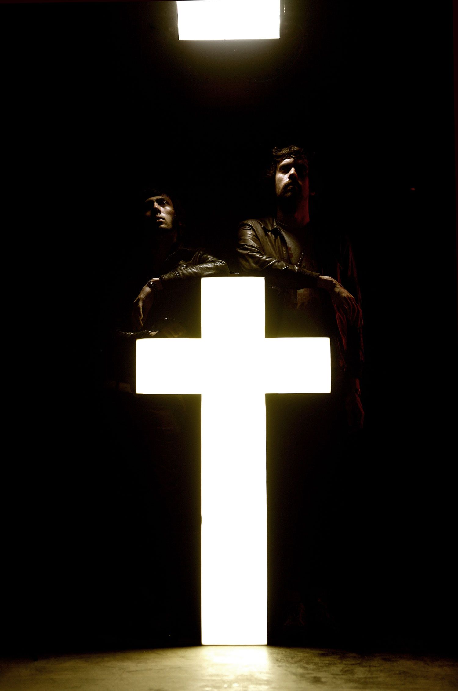 Two Men Embracing the Light of the Night