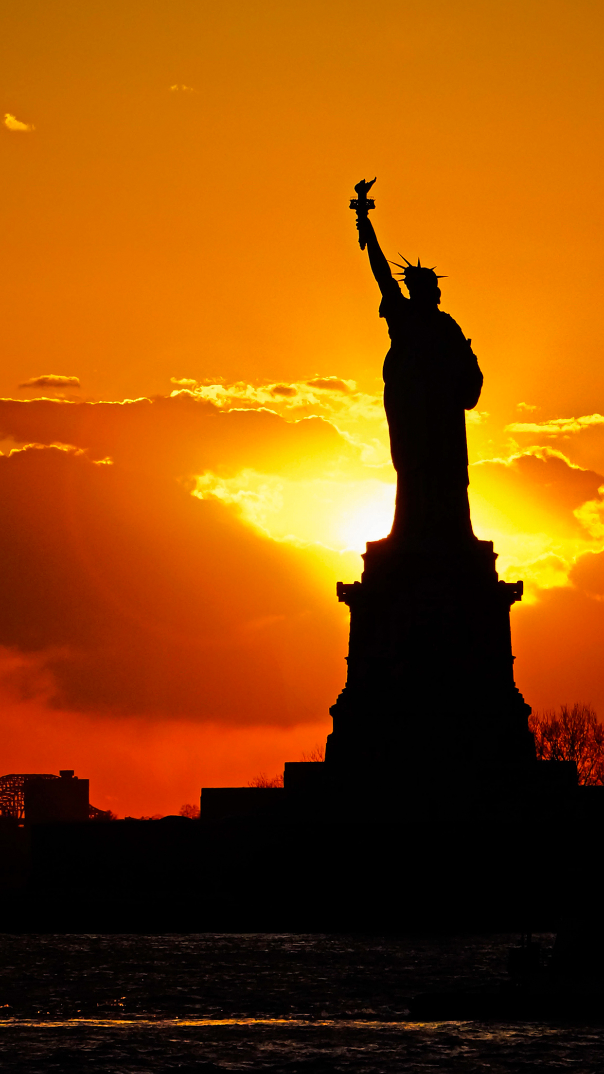 Sunset behind Statue of Liberty