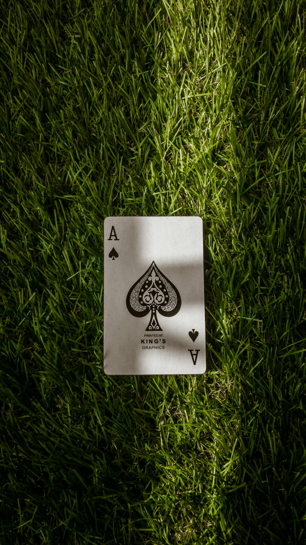 spade playing card on green grass
