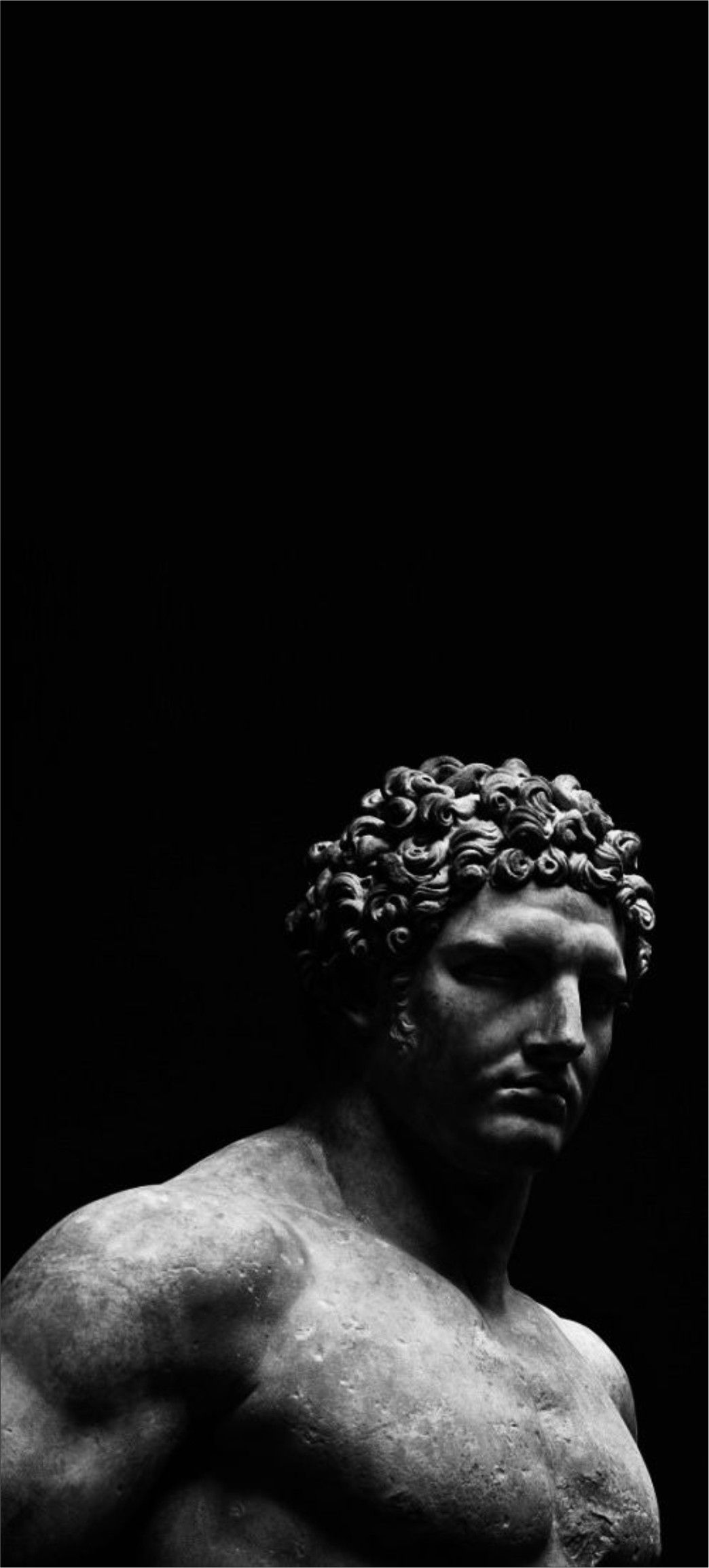 Black and White Statue of a Man with Curls