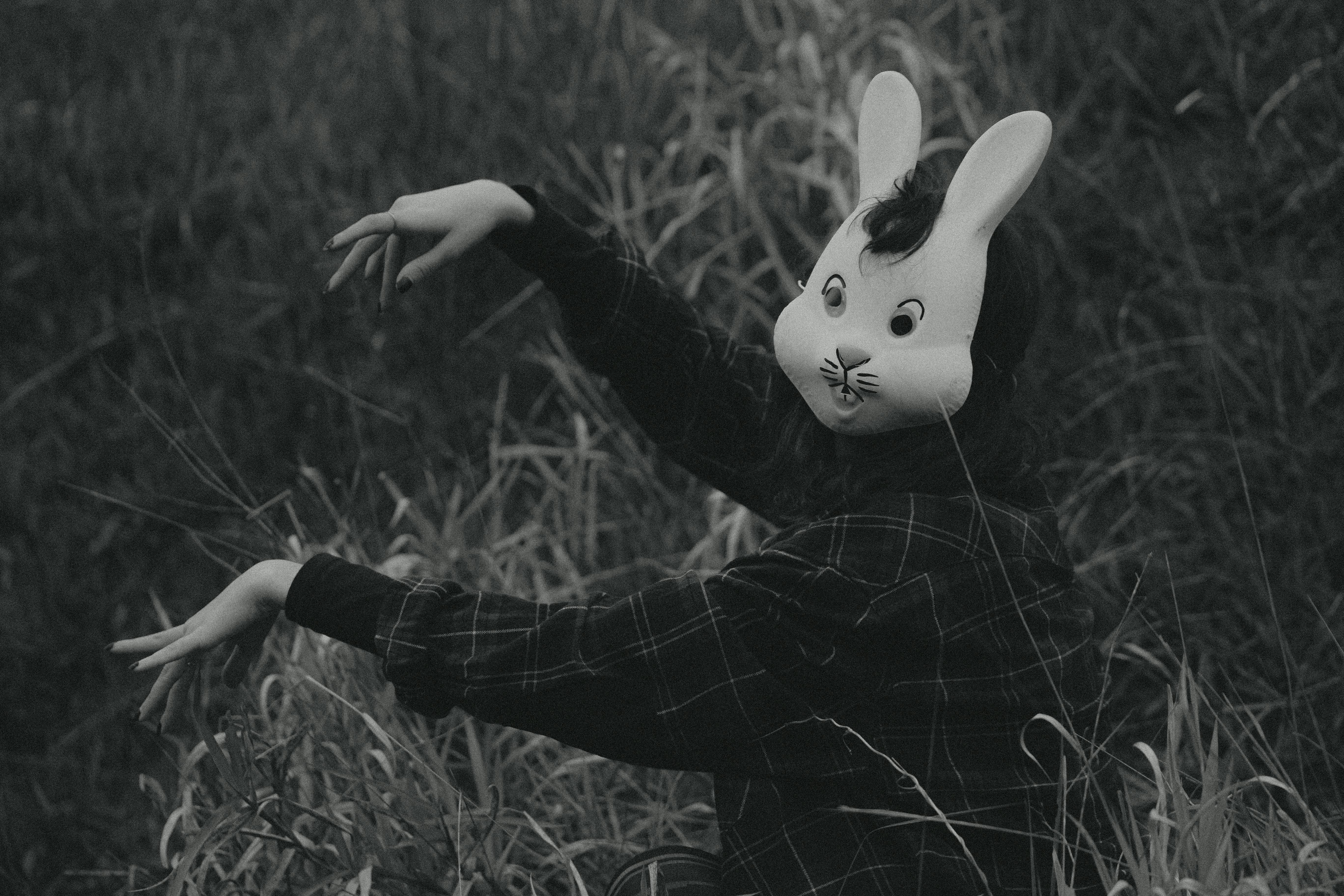 Woman in Bunny Mask Posing in Grass