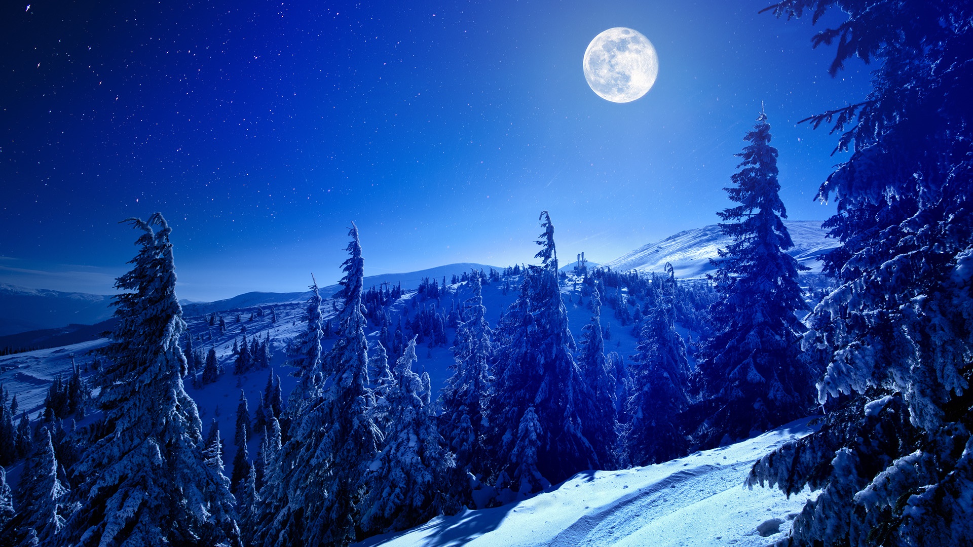 Full moon above the snowy mountains