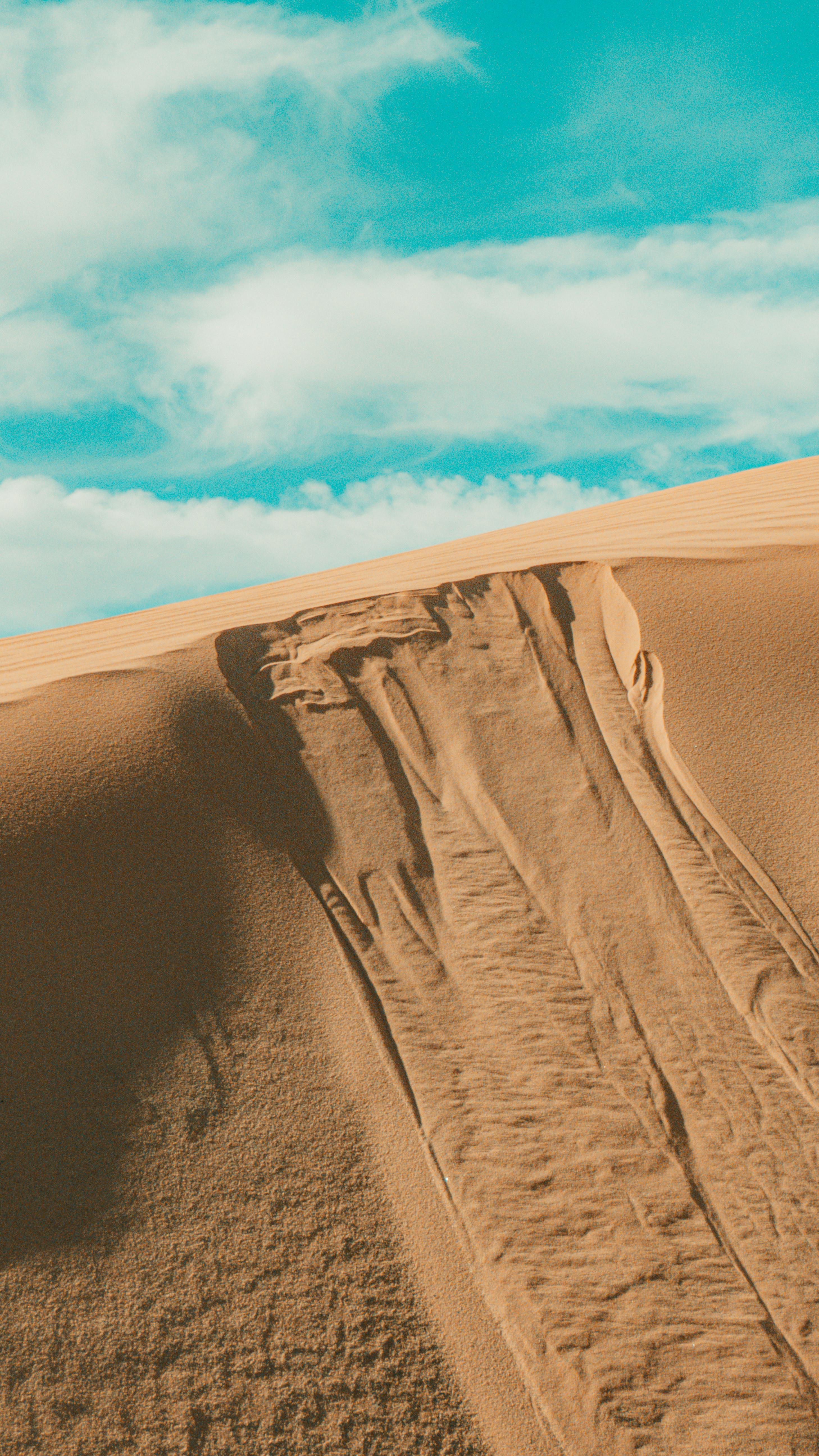 View of a Sand Dune under Blue Sky