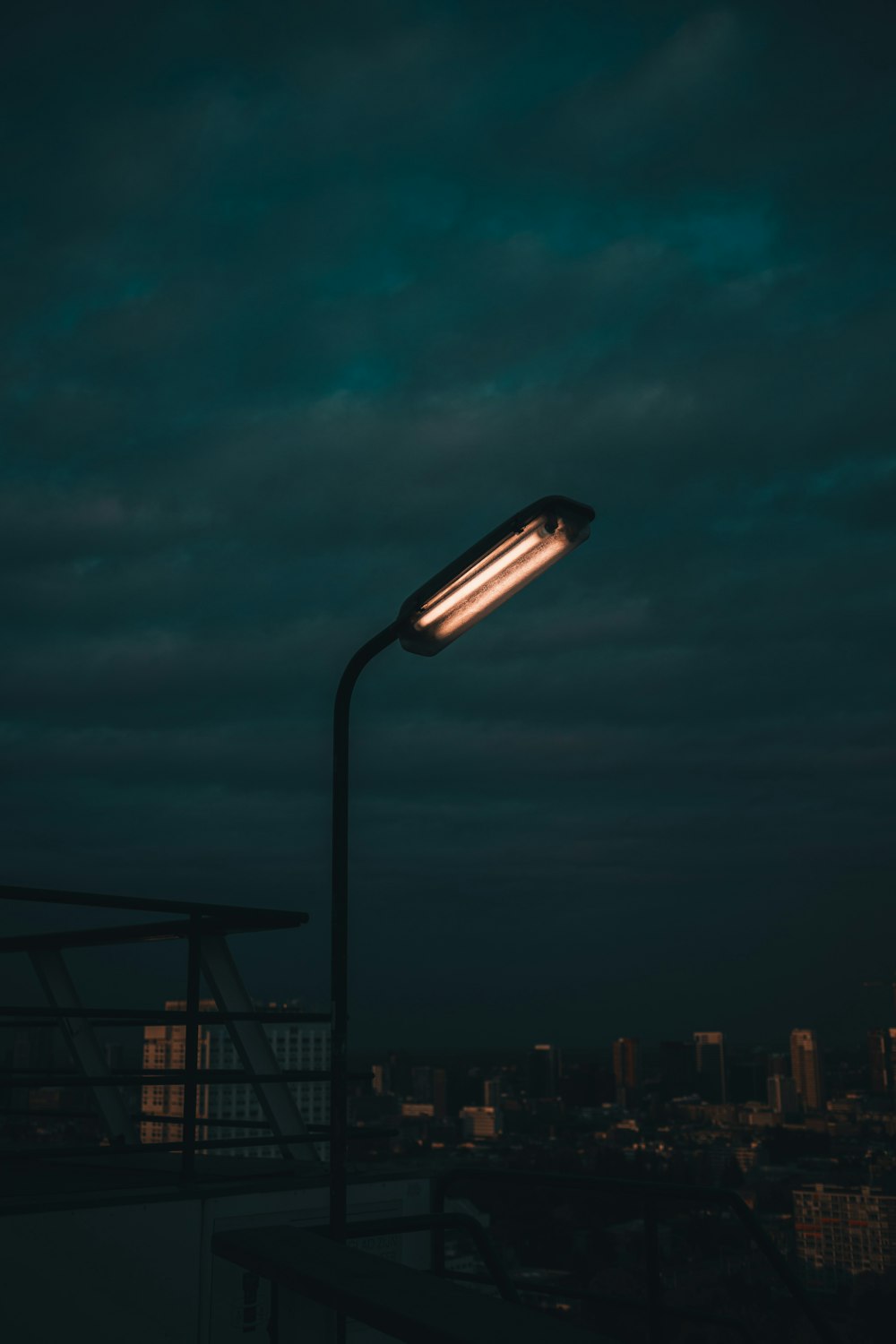A street light in the dark with a city