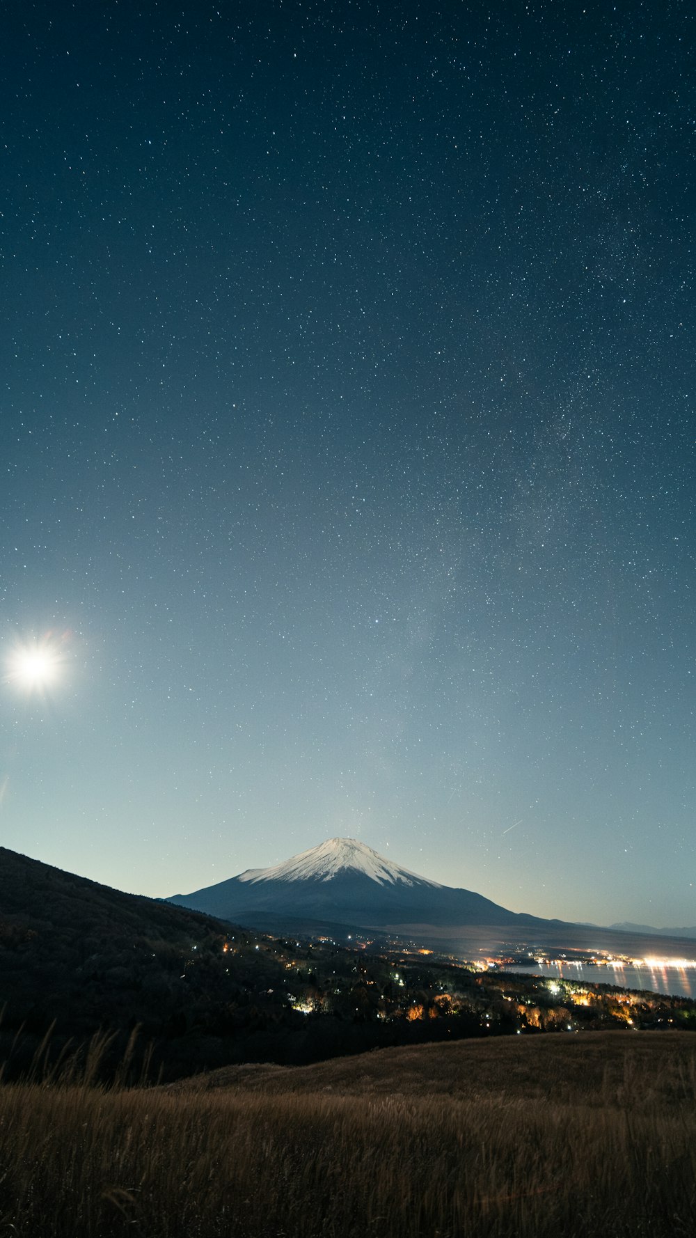 A view of the night sky with a mountain