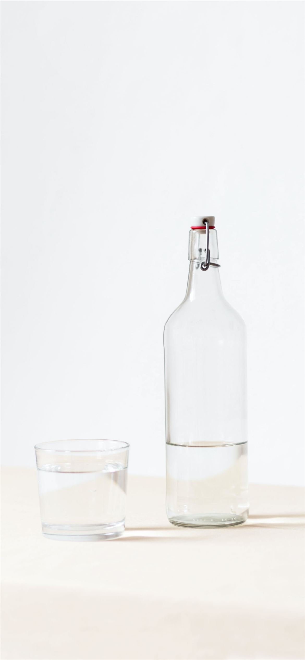 rocks glass beside half empty bottle