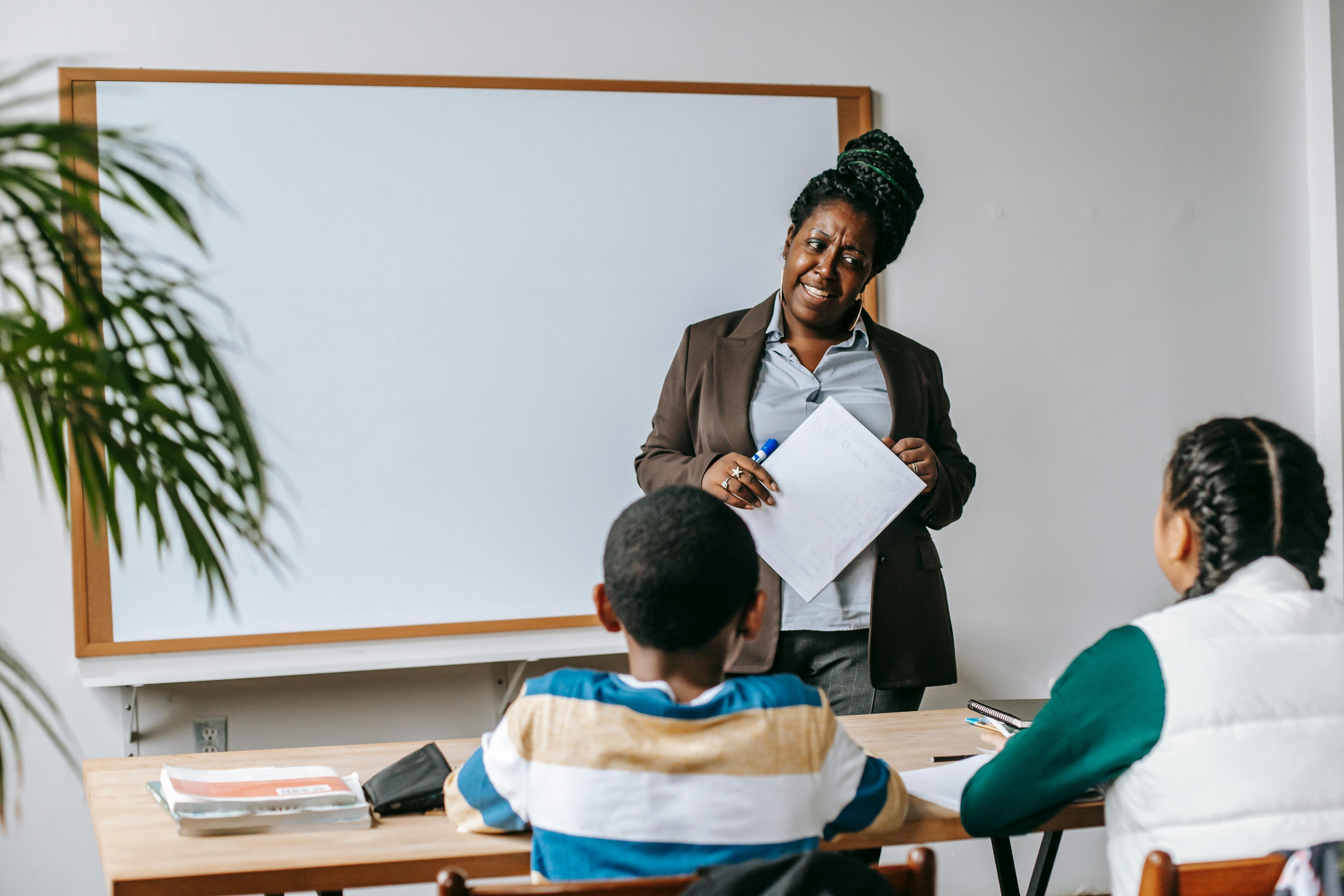 Black teacher with kids in modern