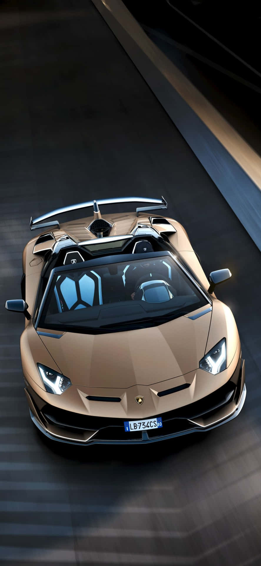 An iPhone X and Lamborghini parked side